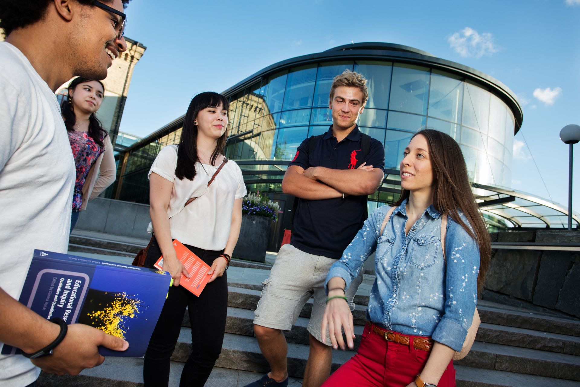 A group of people engaged in conversation in an urban setting.