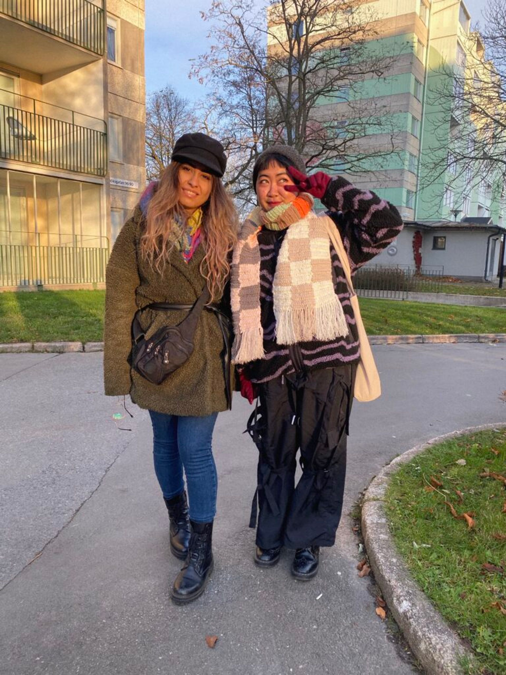 Two international students with colourful winter outfits.