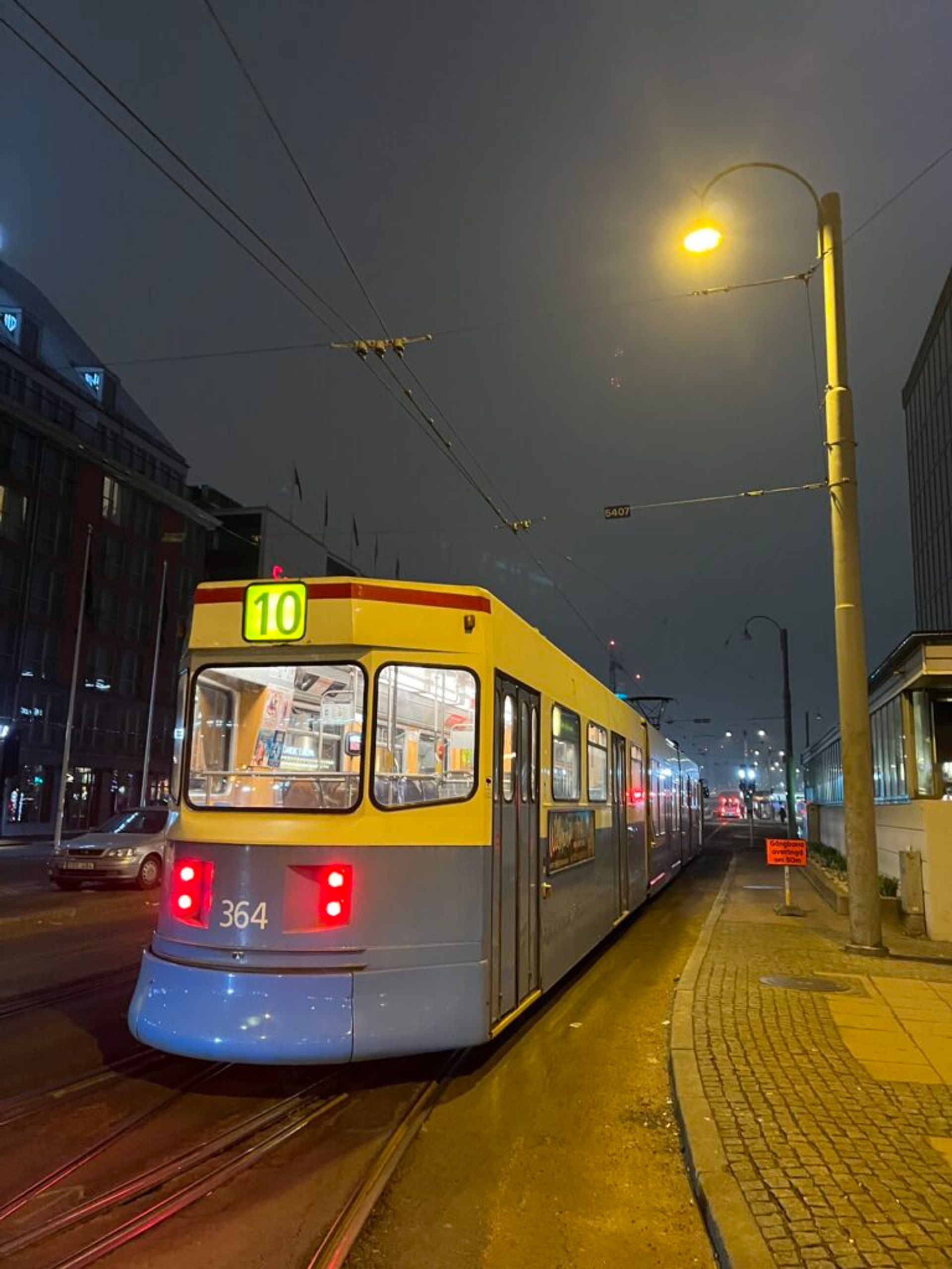 A tram in motion in an urban setting.
