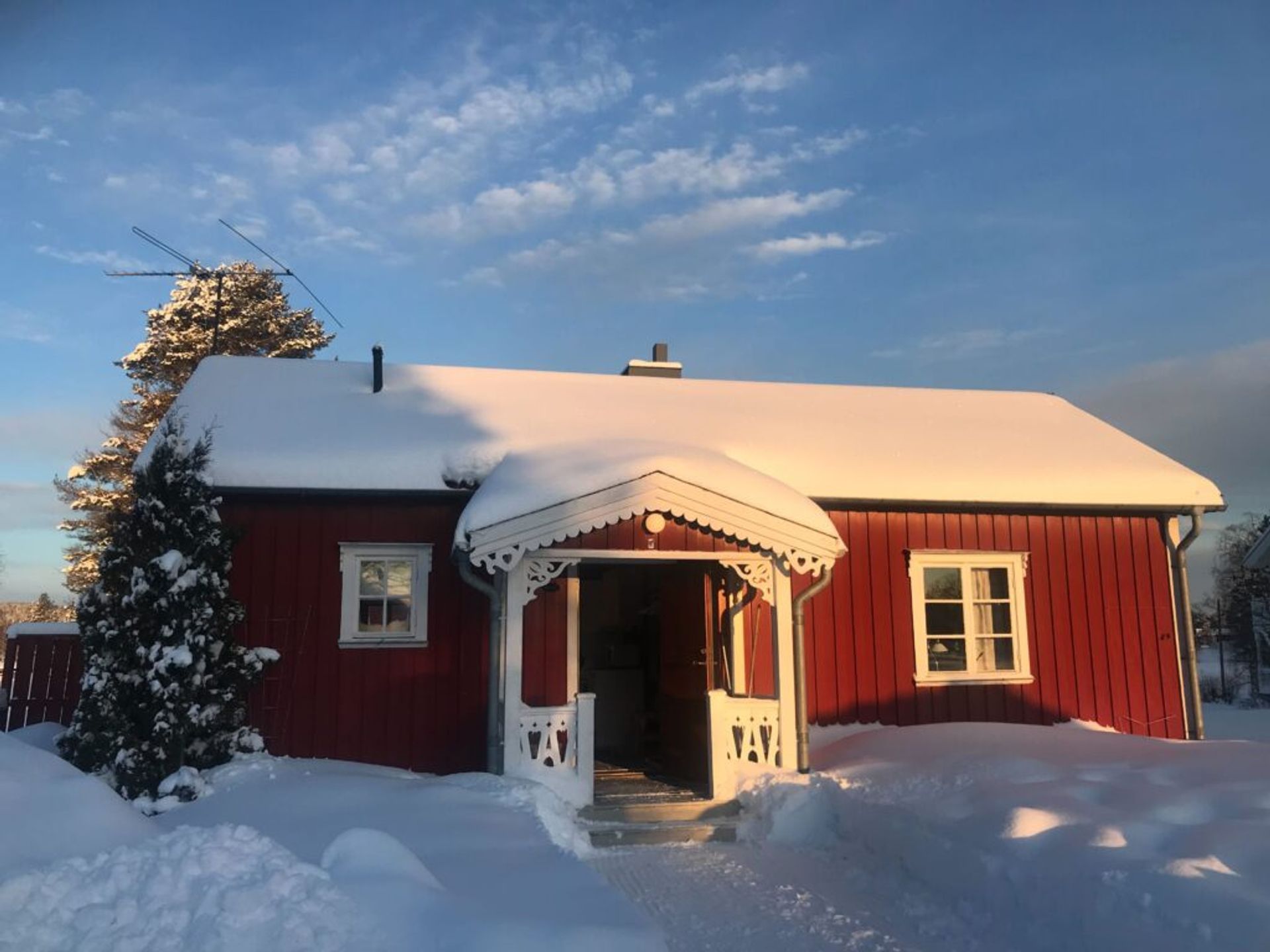 Red cottage covered with snow
