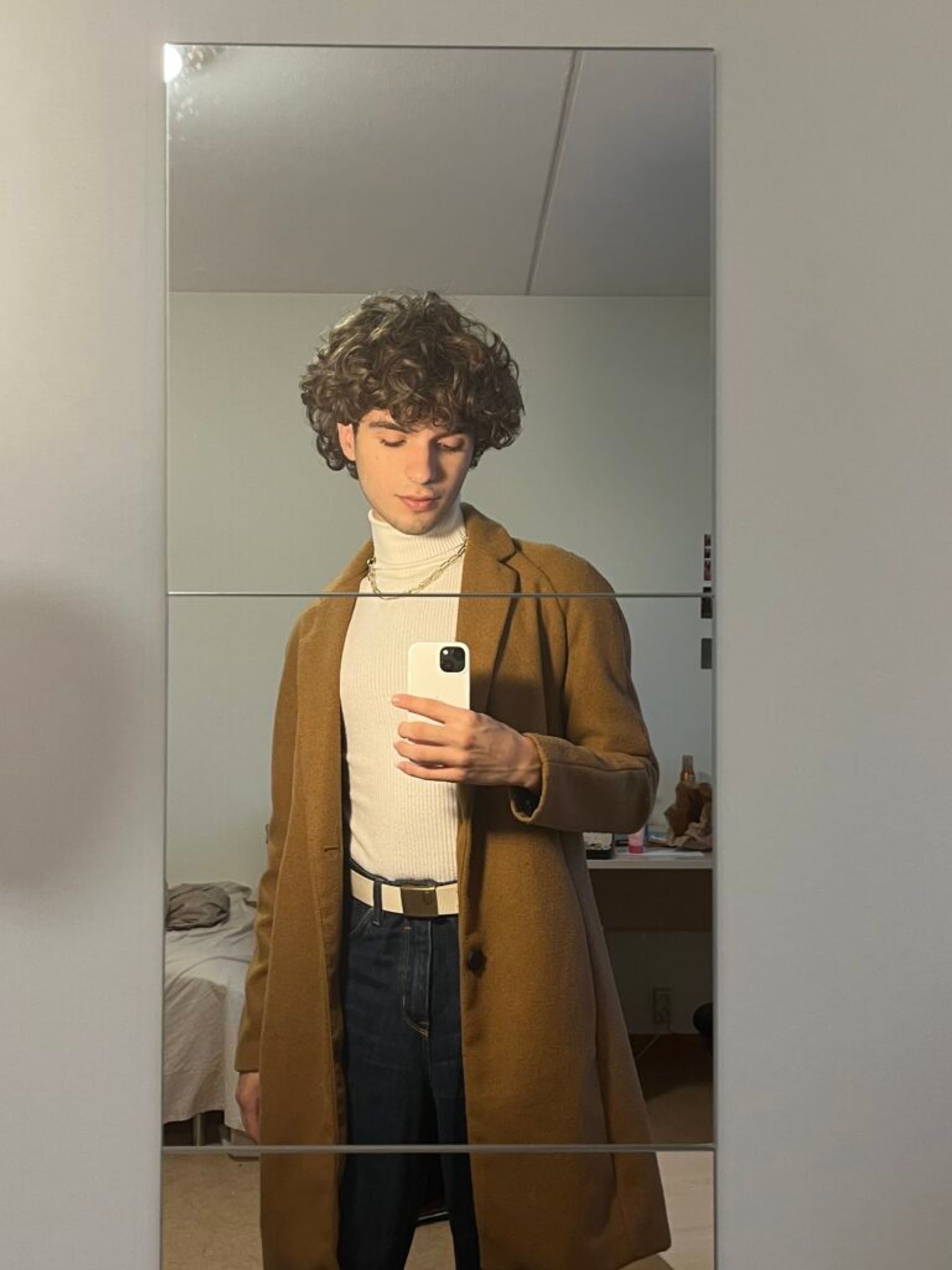 A mirror selfie showcasing a winter outfit by Chris.