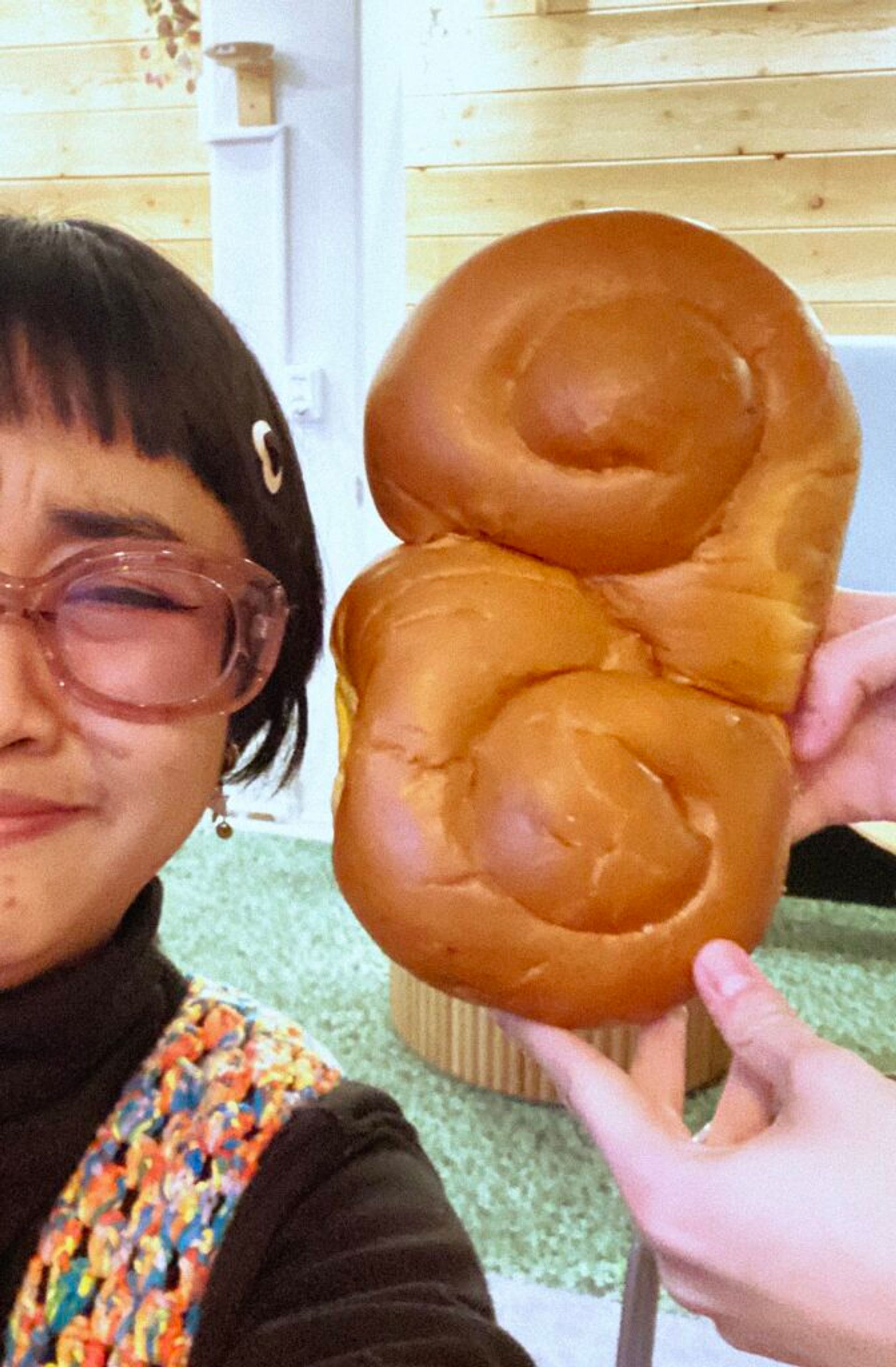 An international student with a very big lussekatter or lussebulle bread from Sweden