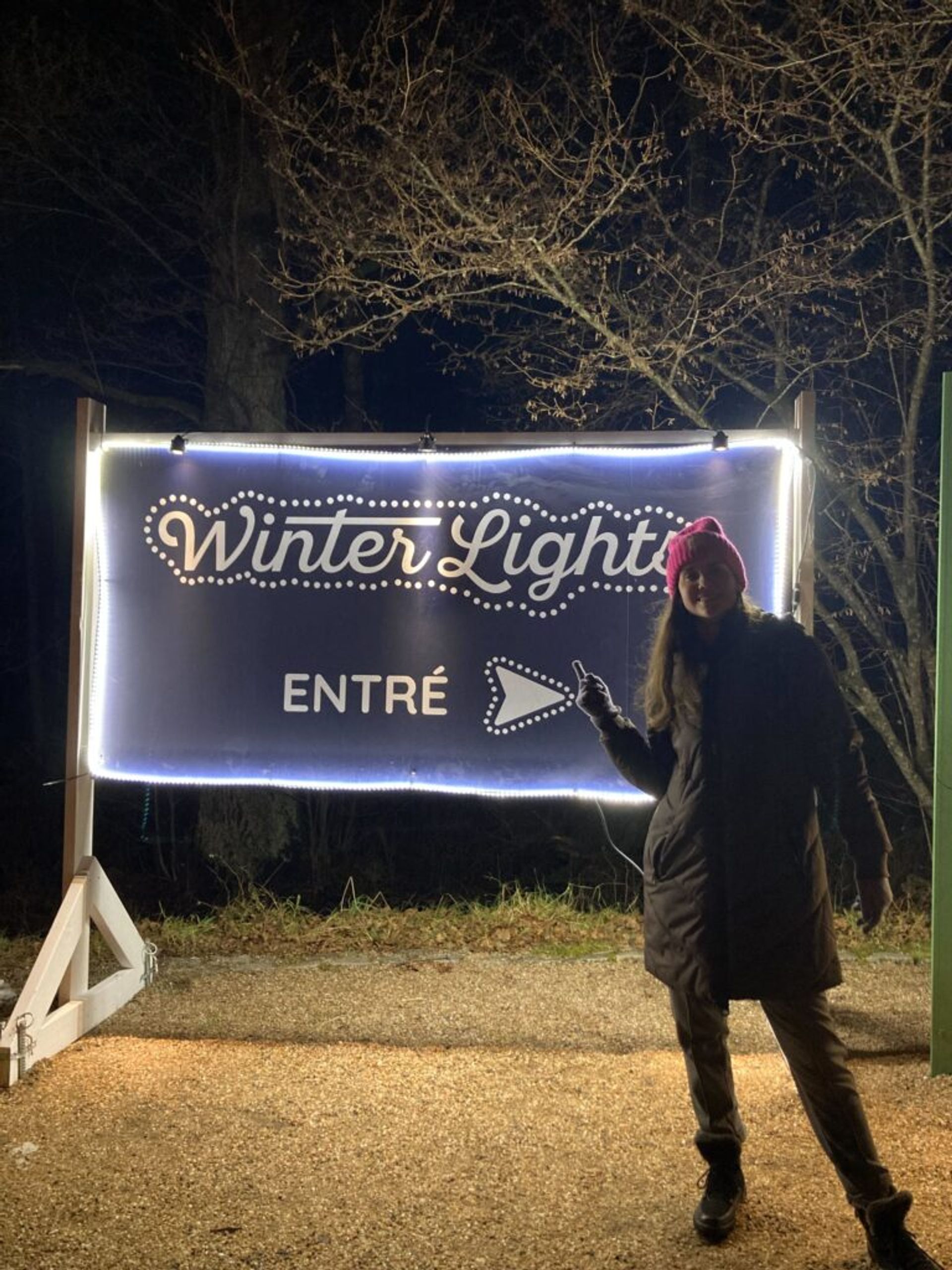 A girl standing by a sign