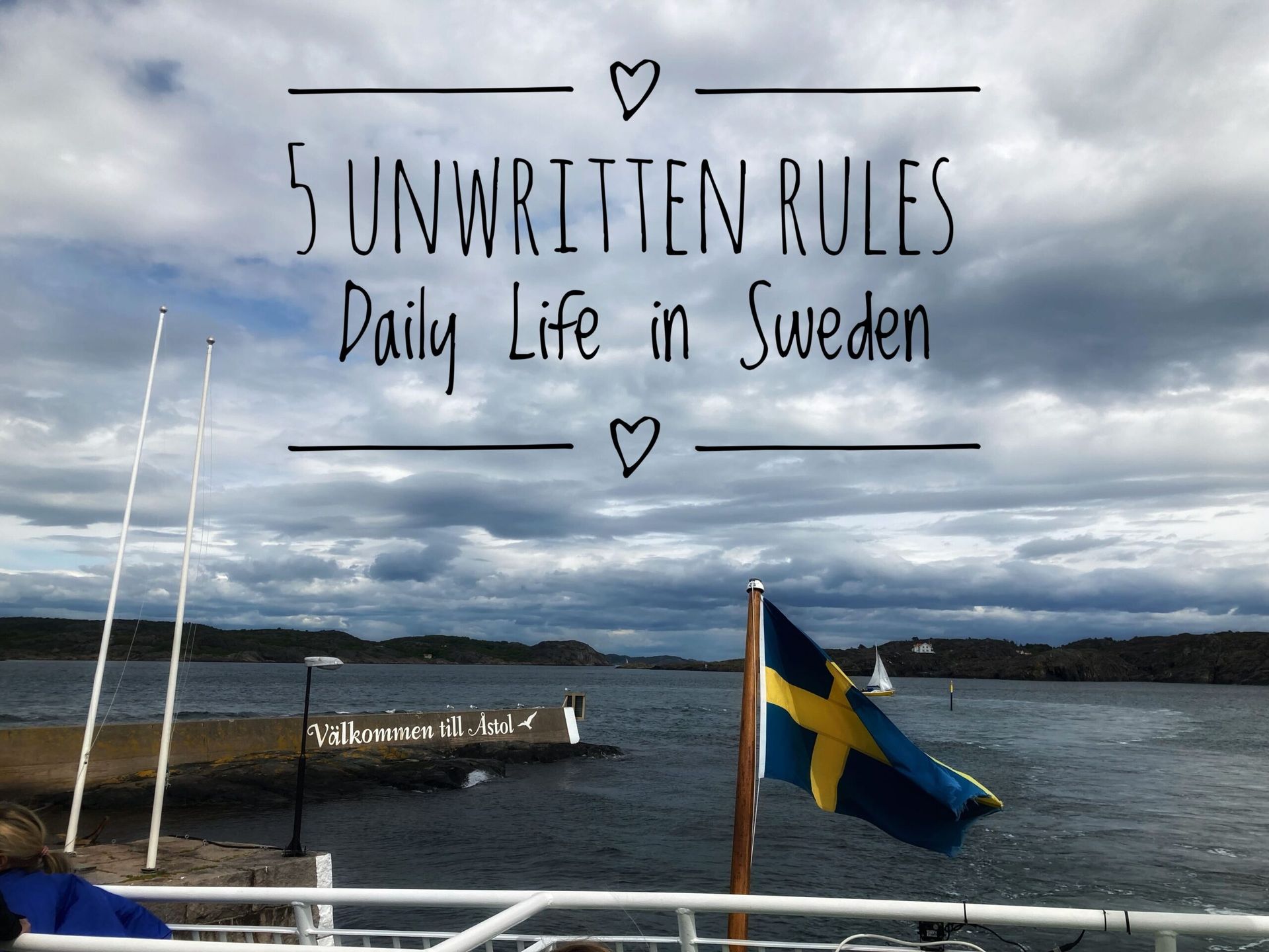 A photo taken on a cloudy day by a port where a Swedish flag can be seen flapping in the wind. The blog's title "5 Unwritten Rules - Daily Life in Sweden" is placed on the top of the image.