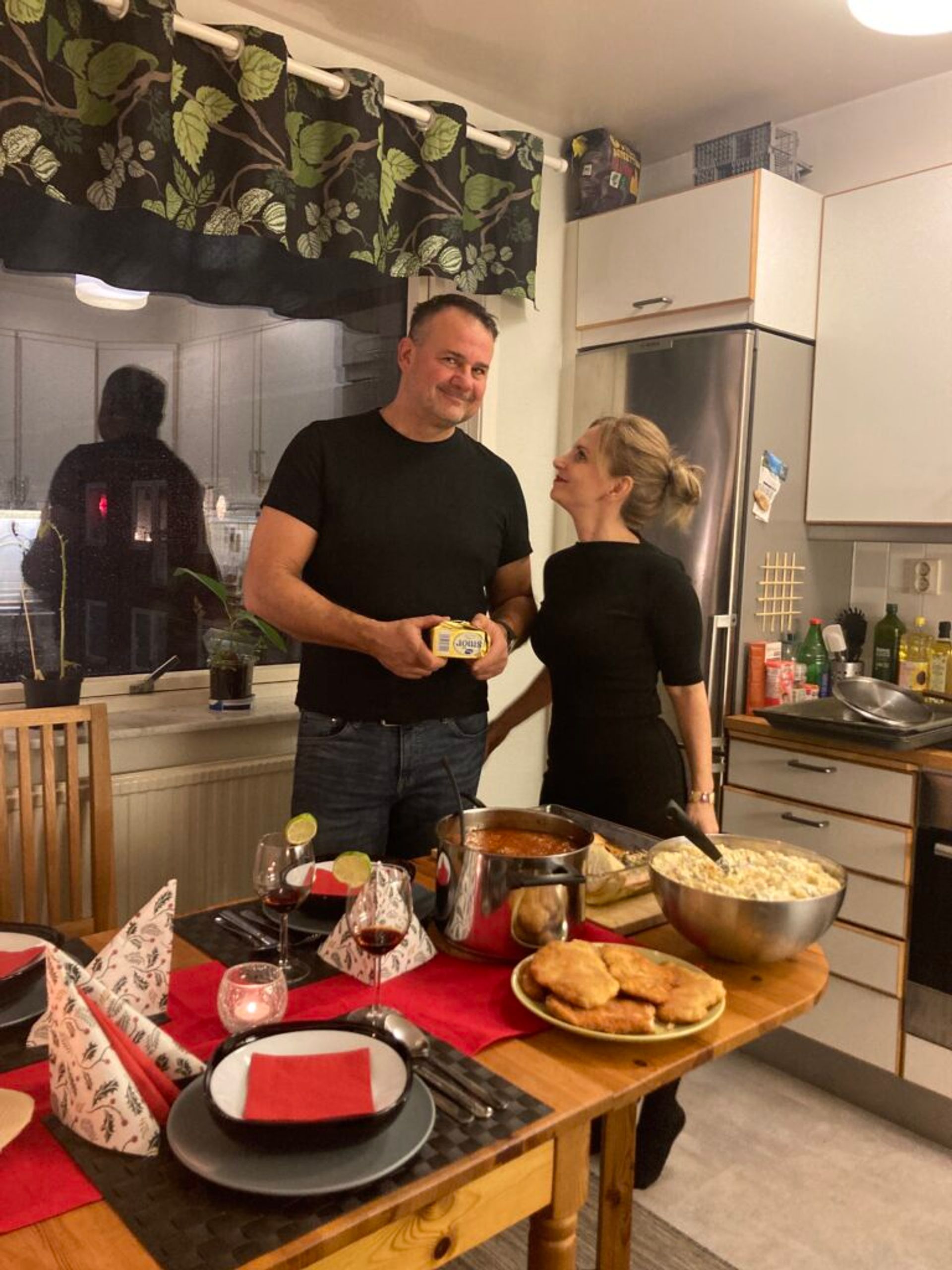 Parents standing by a Christmas table