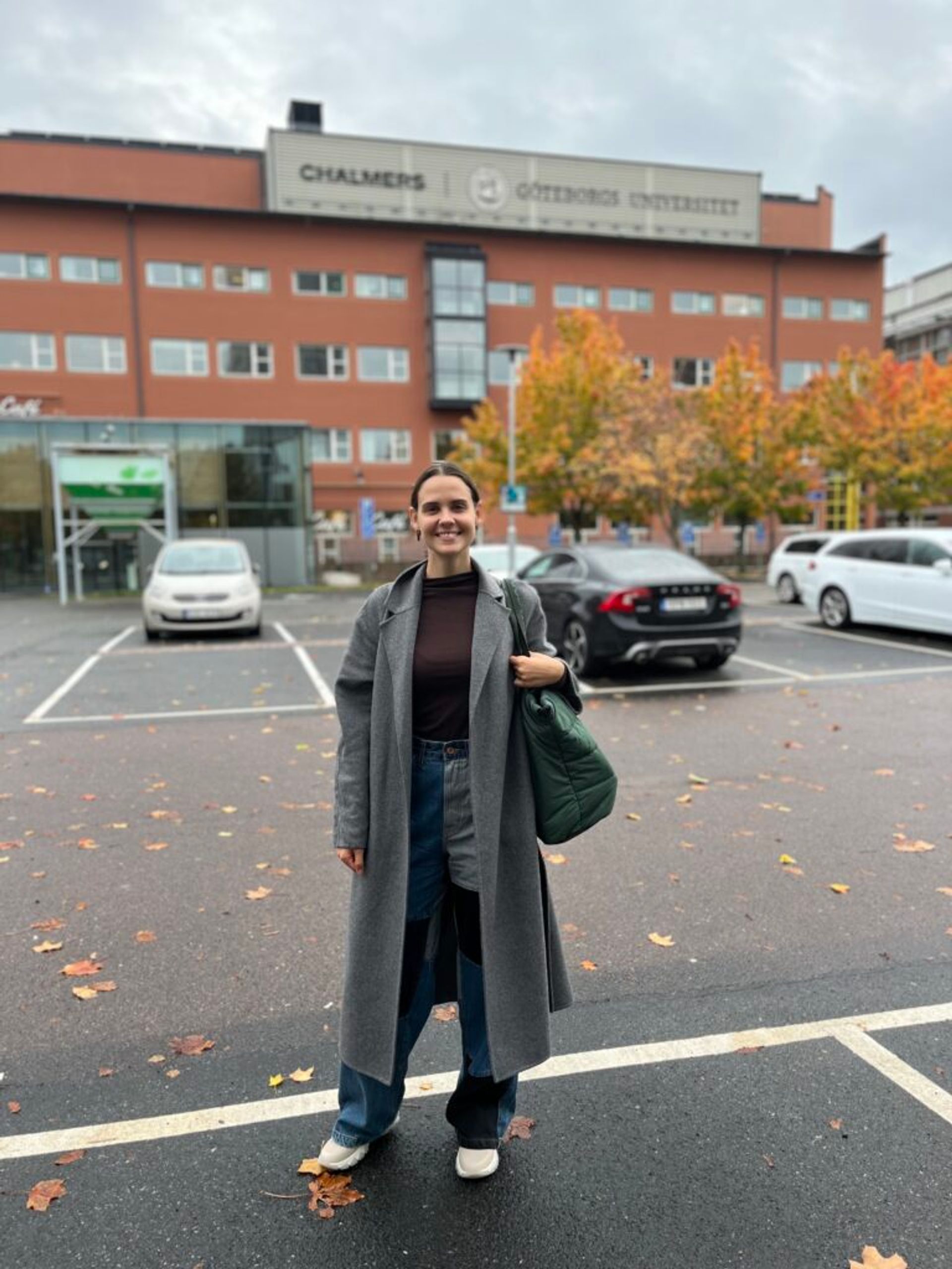 A girl standing in front of a building.