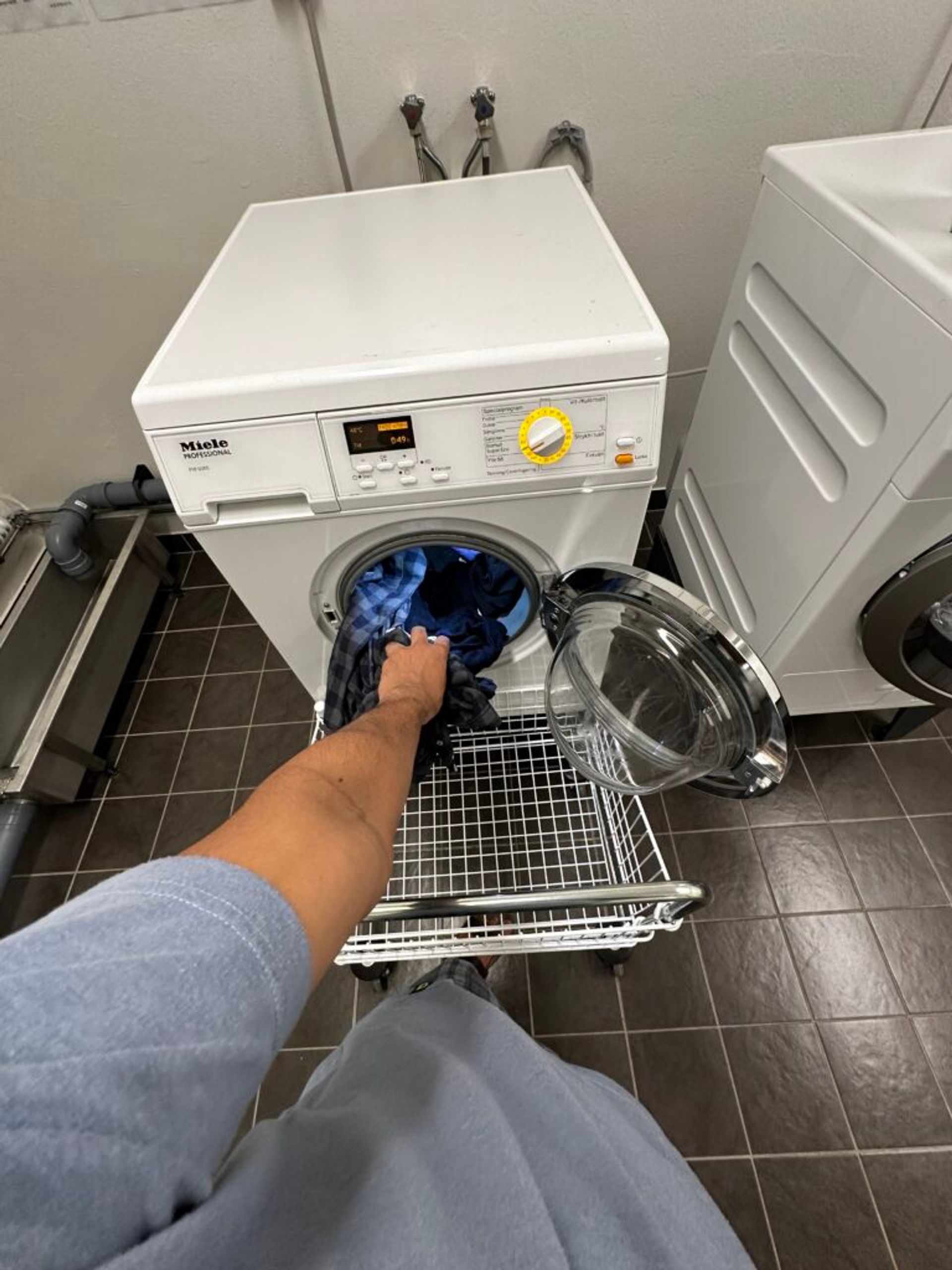 student getting laundry out of a washer