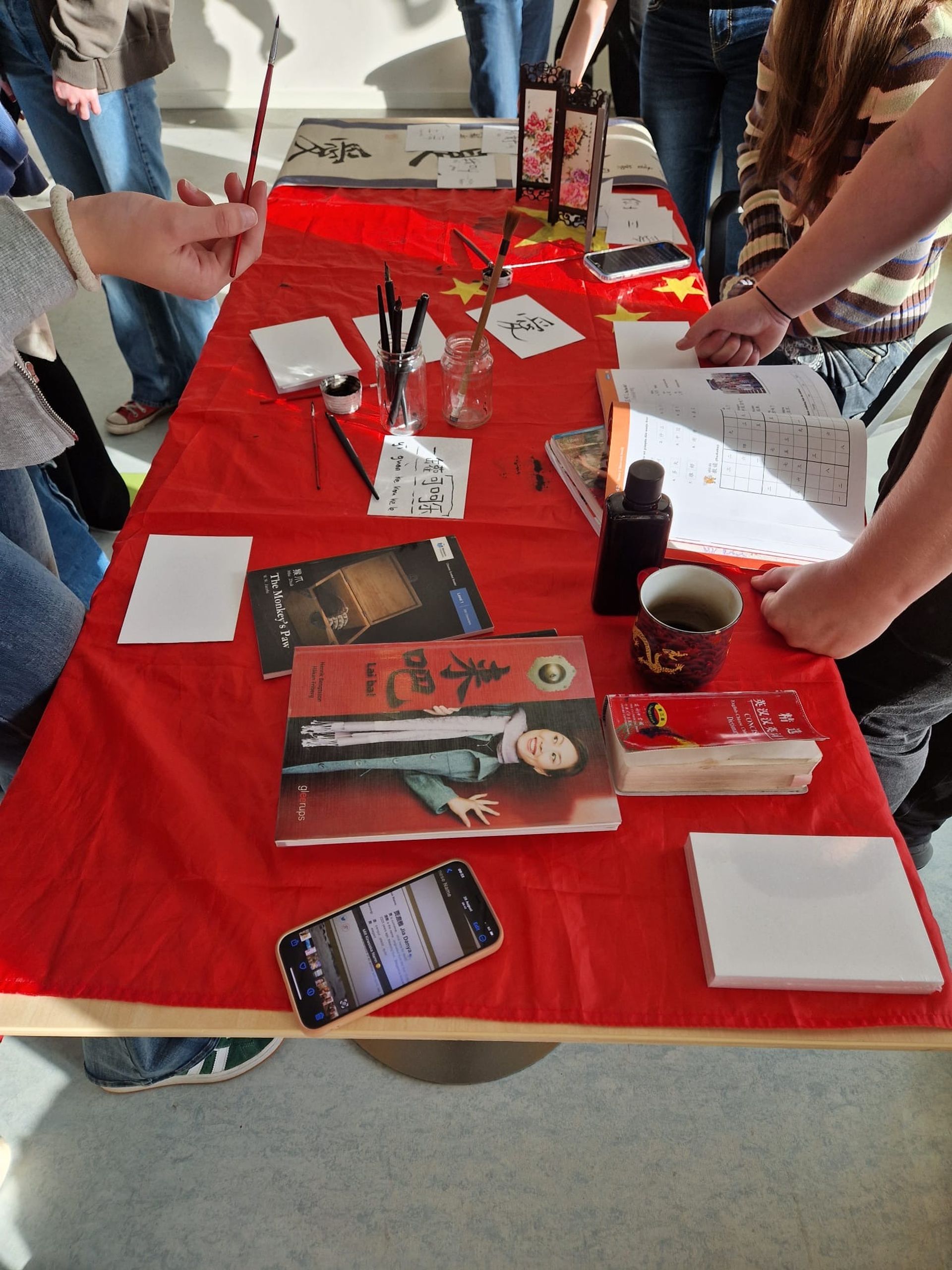 A table with books and items belonging to different cultures