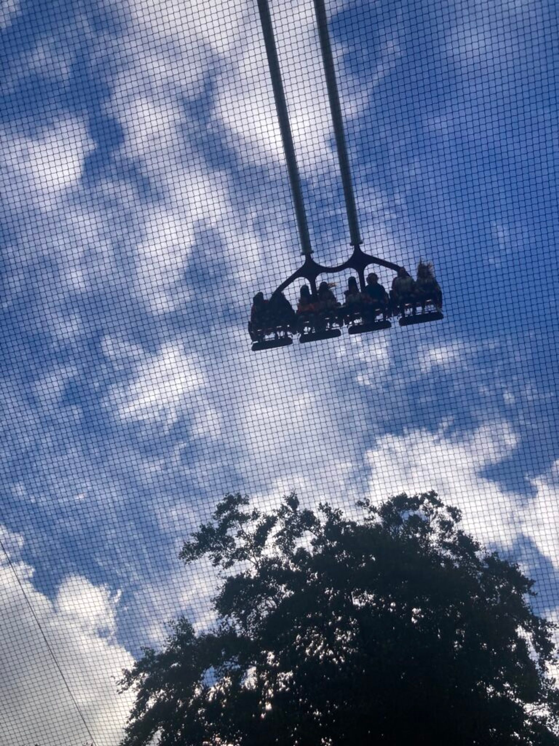 People on a roller coaster in the sky.