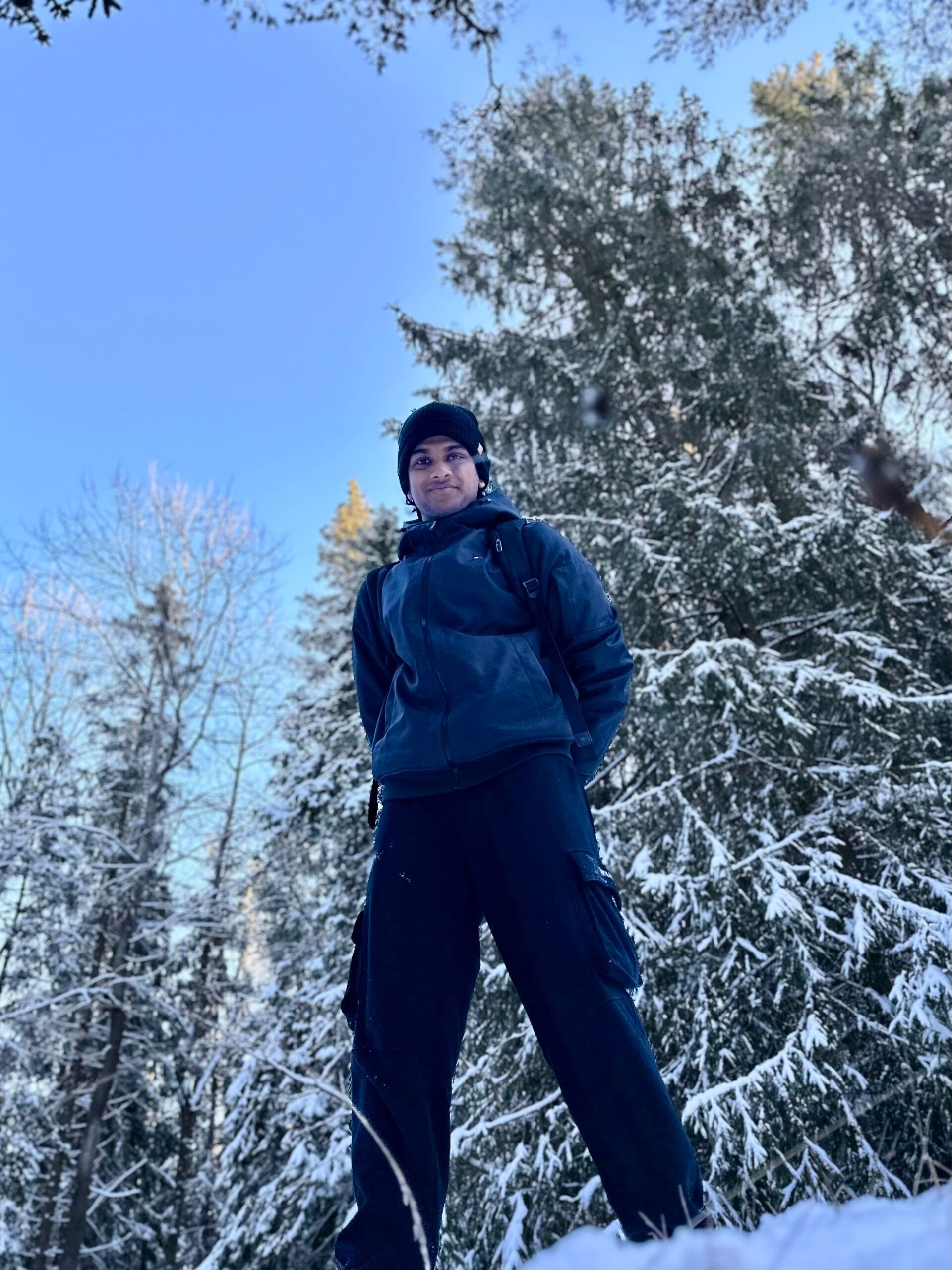 A boy standing surrounded by a snowy landscape