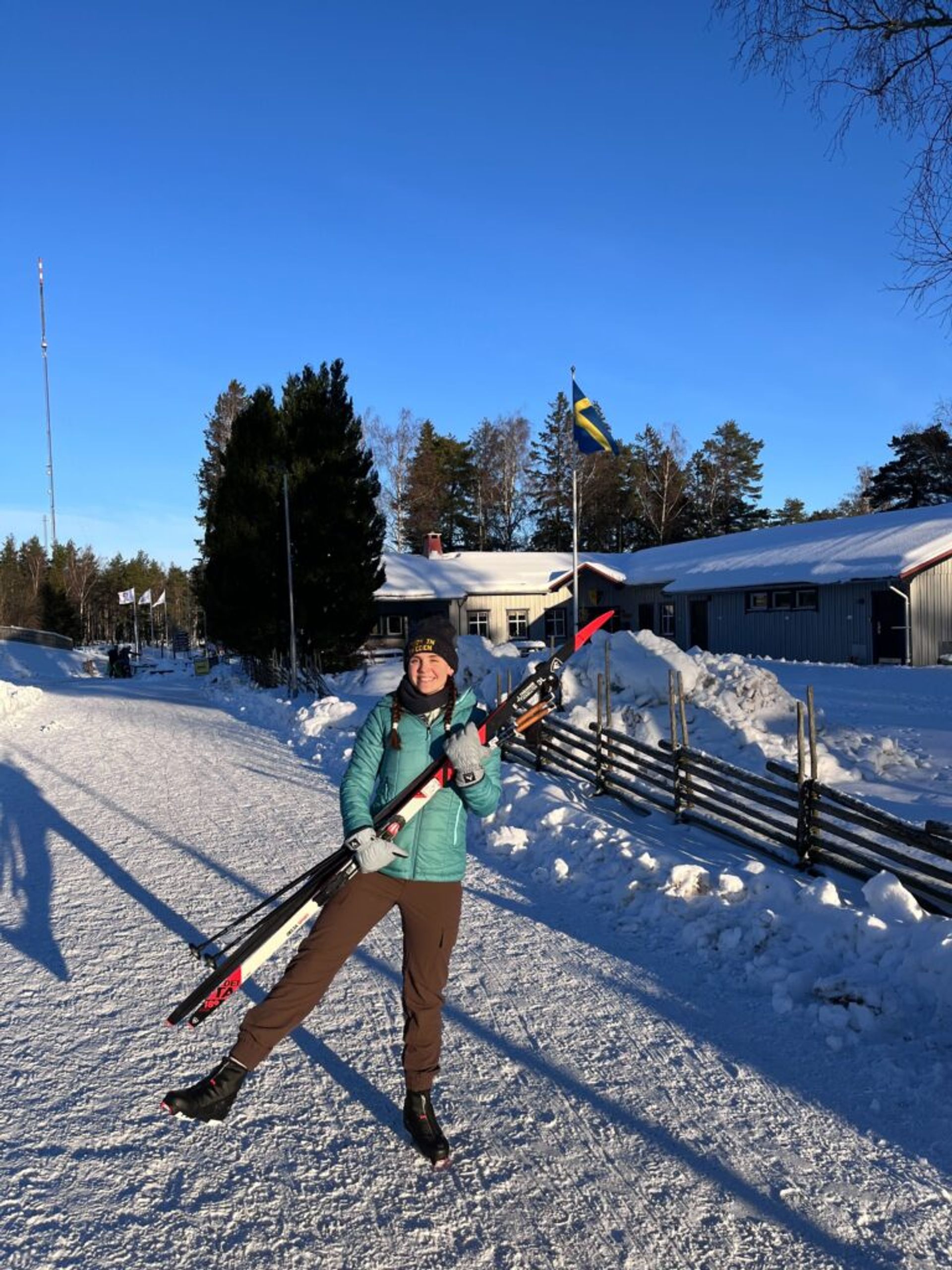 A girl holding skis.