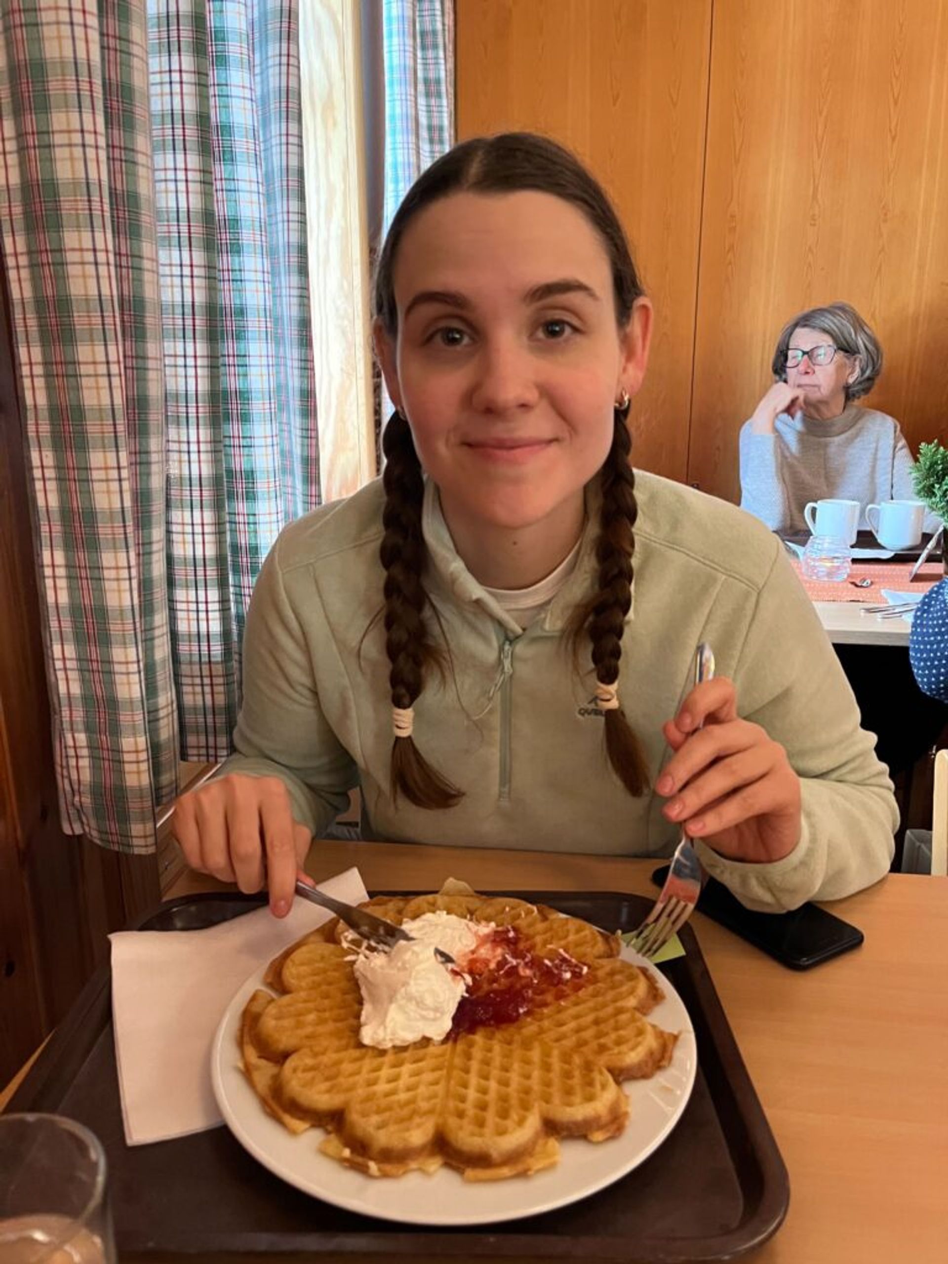 A girl eating waffles. 