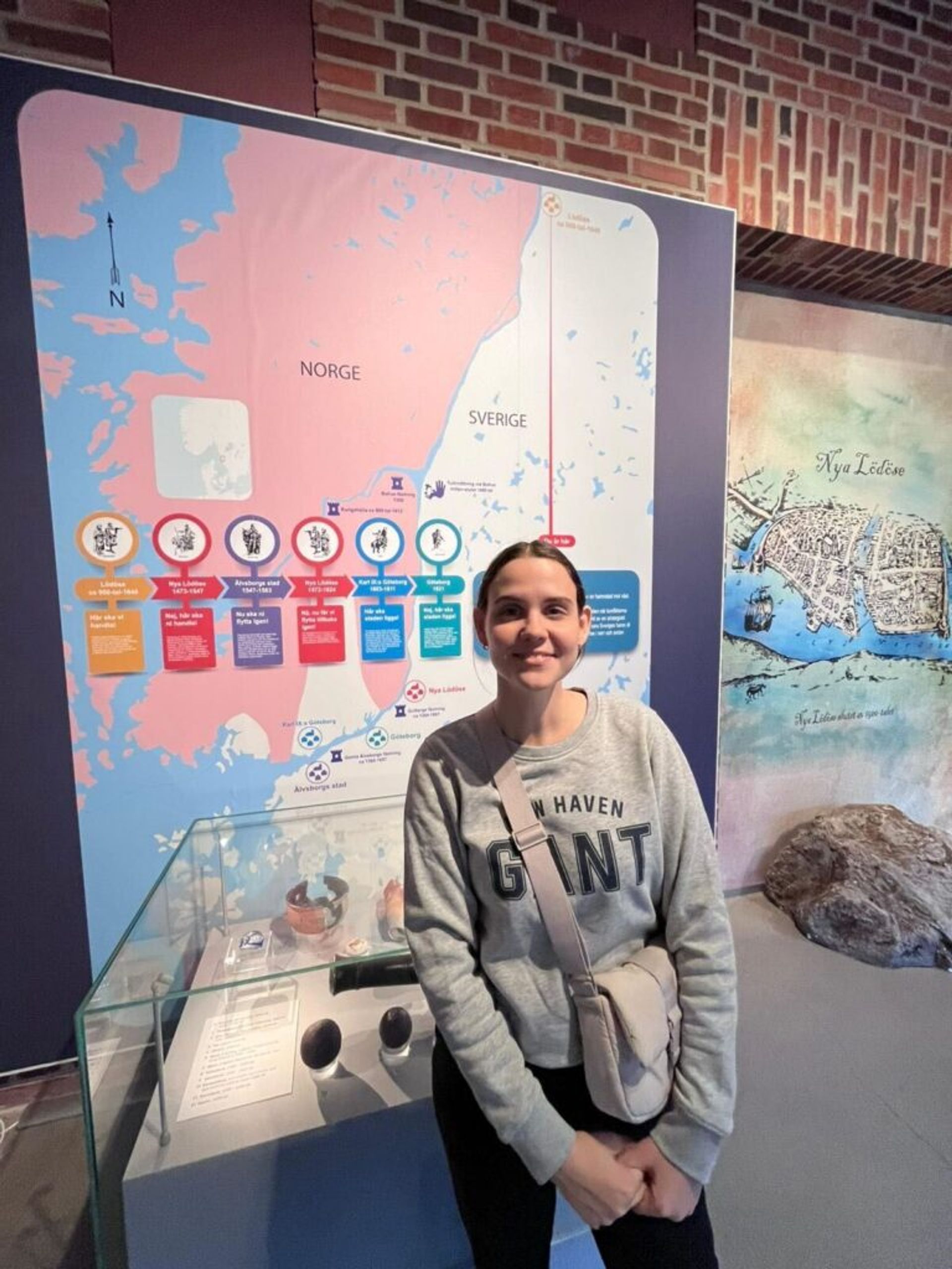 A girl standing in front of a map.