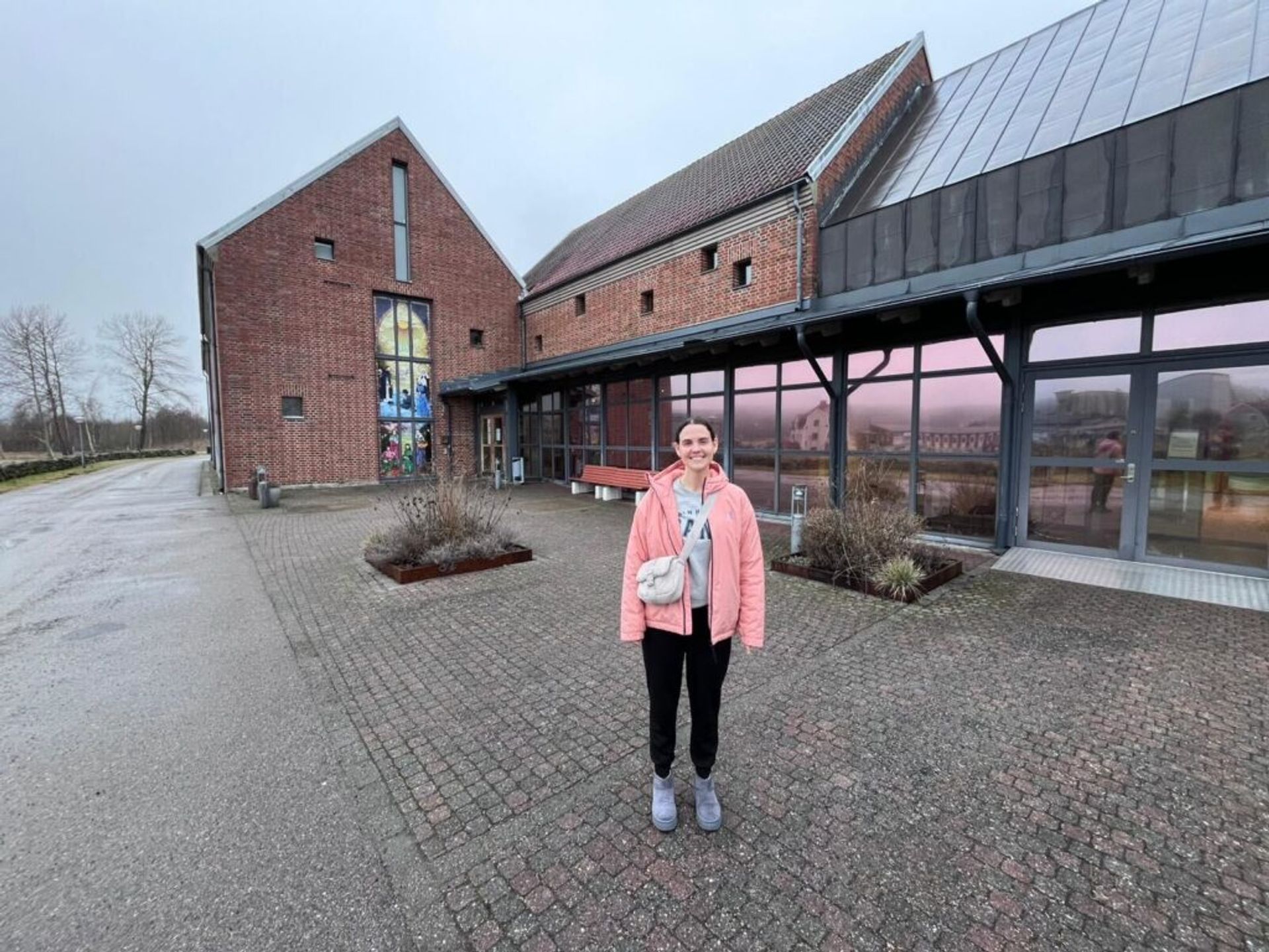 A girl in front of a museum.