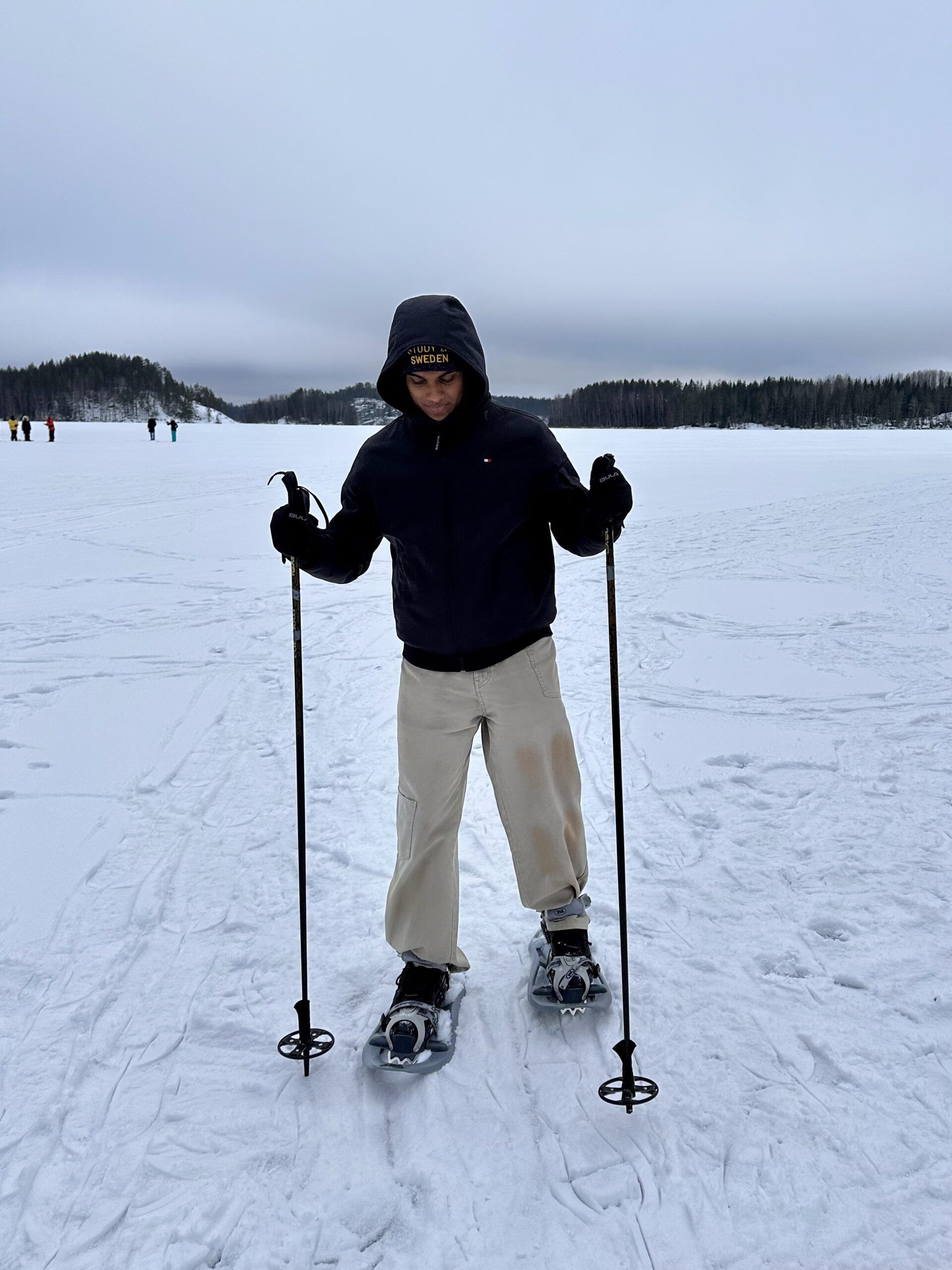 a boy walking with snow shoes