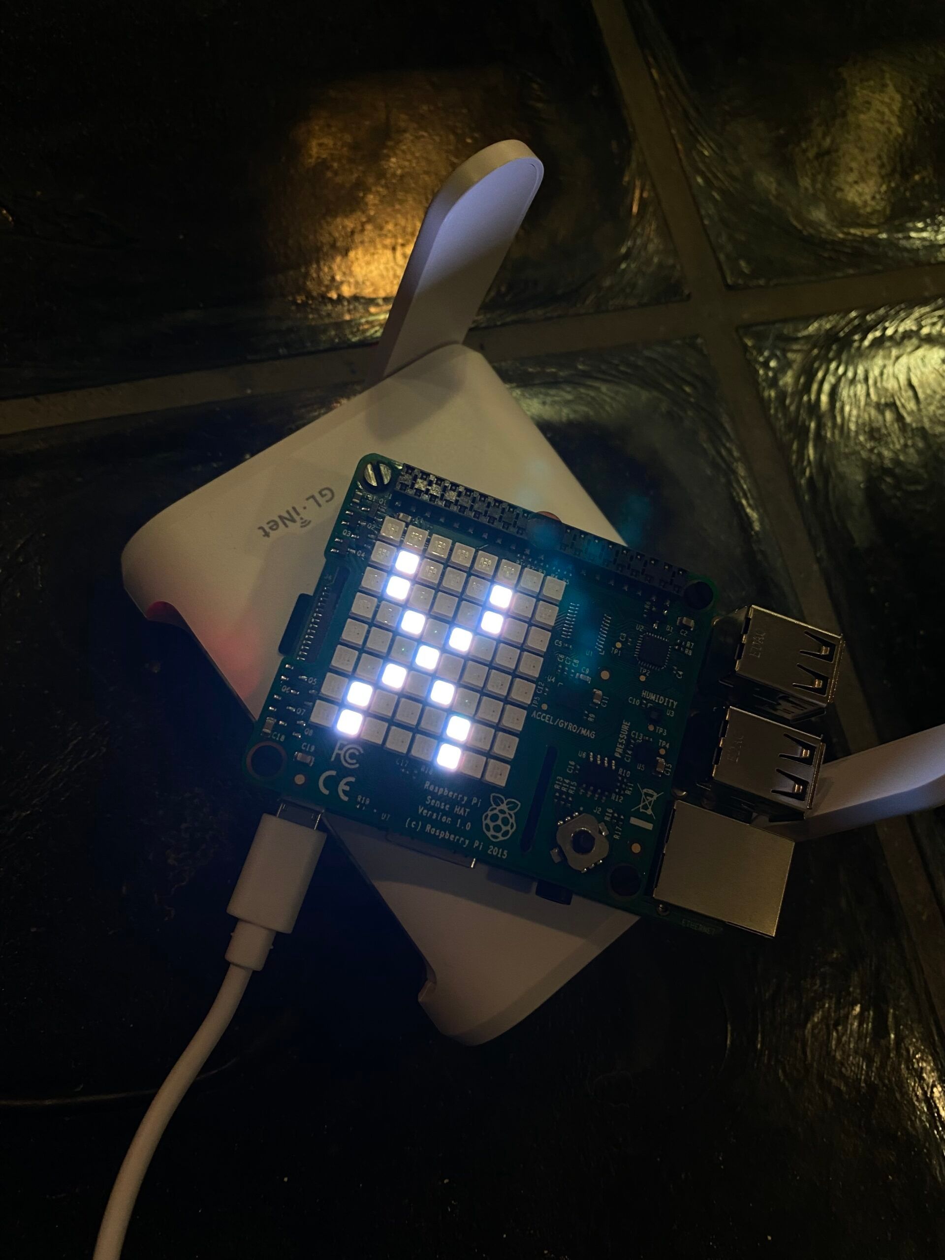 A picture of a wifi router and a programmable light pad