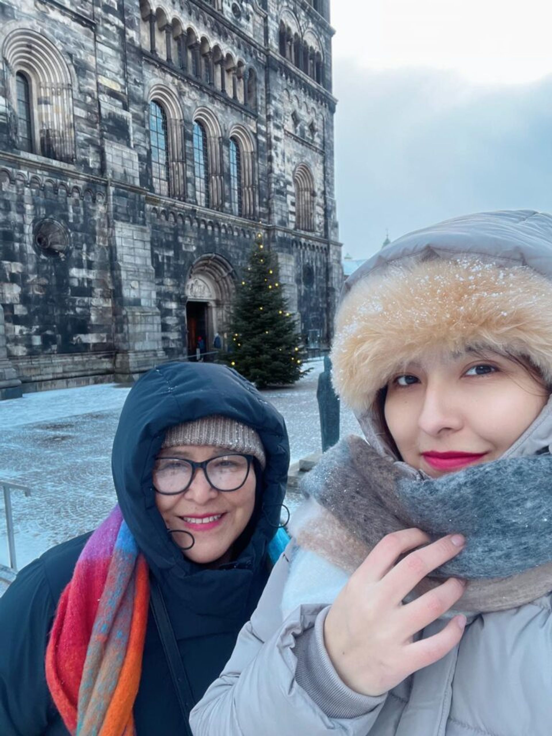 two woman looking happy at the camera