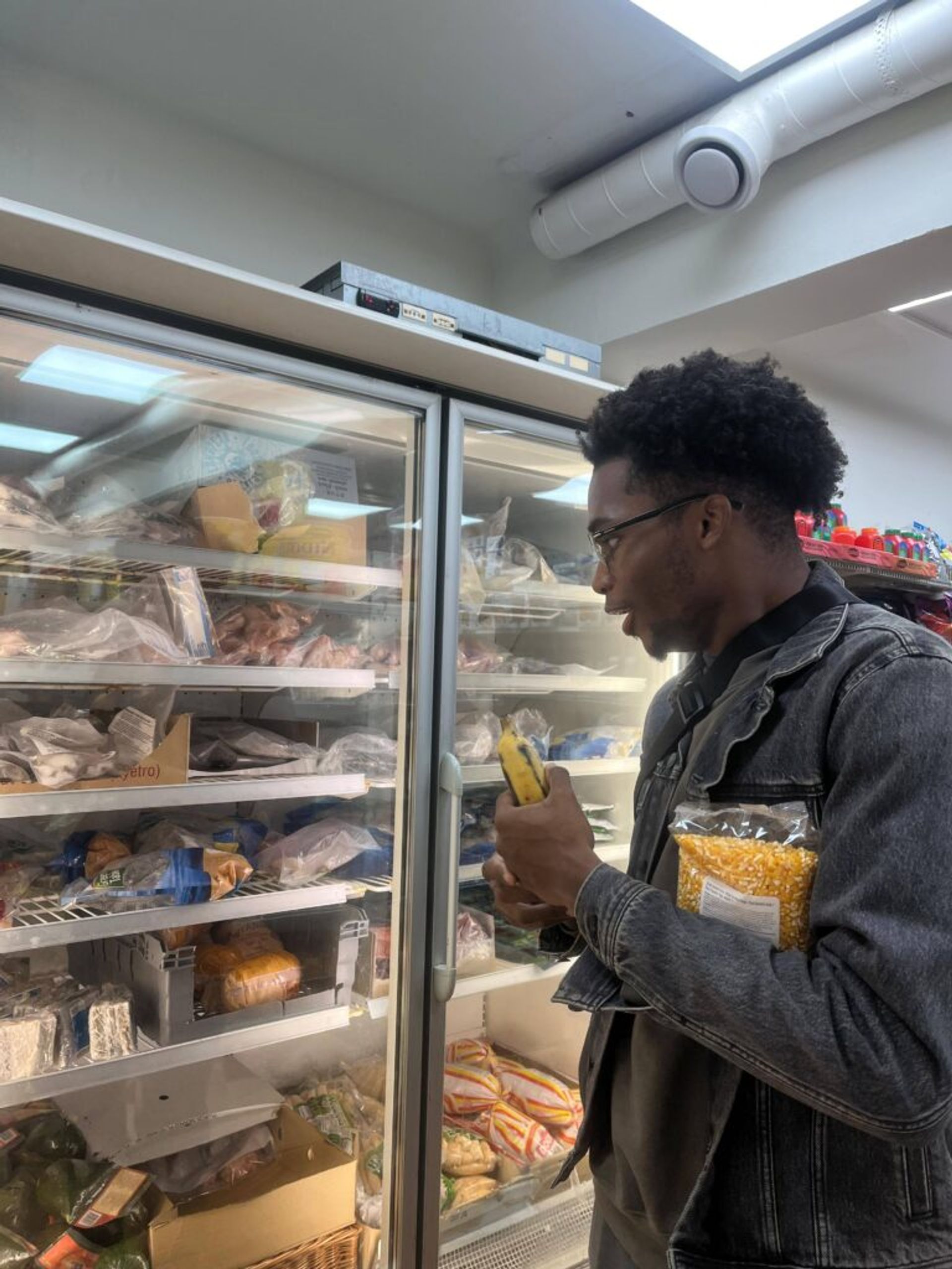 Joshua inside a Taj Mahal looking into the freezer with a shocked look on his face. 