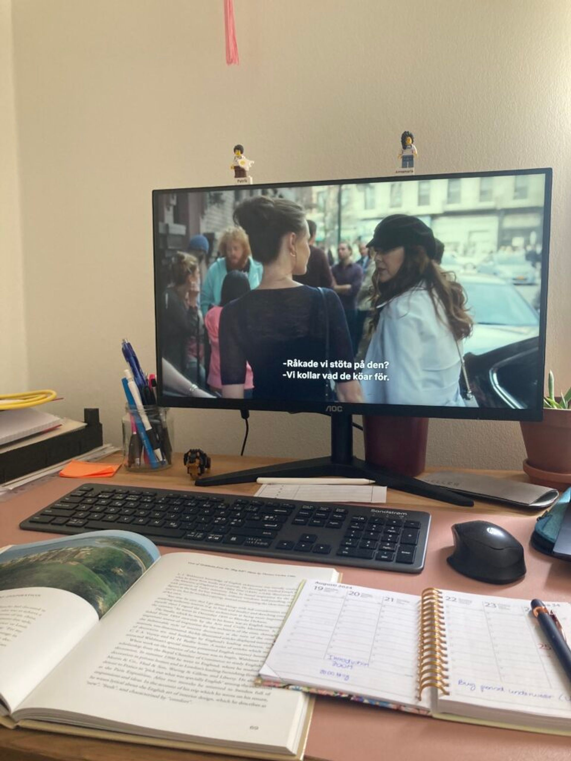 A desk with a computer and notes.