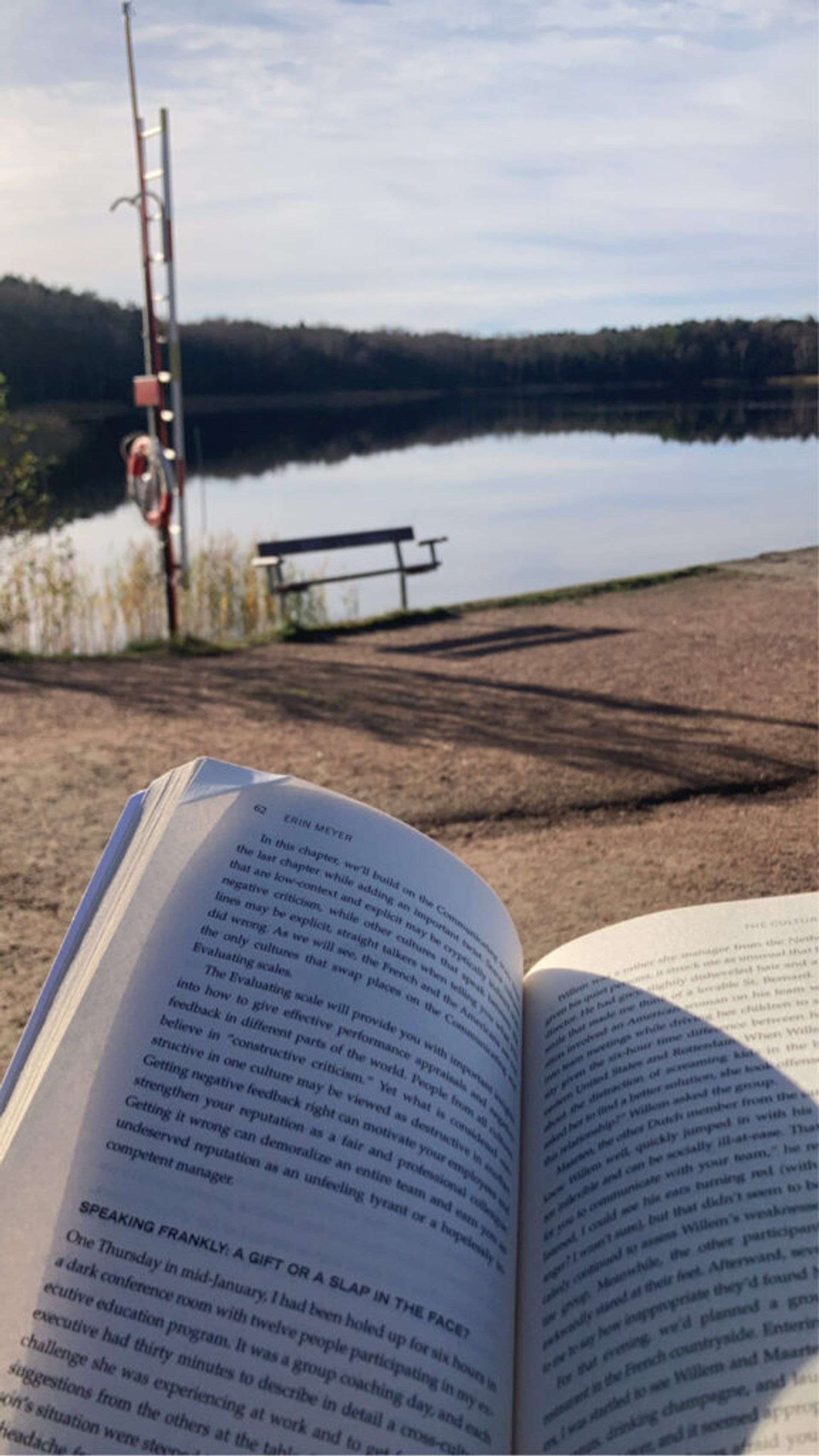 An open book and lake in the background.