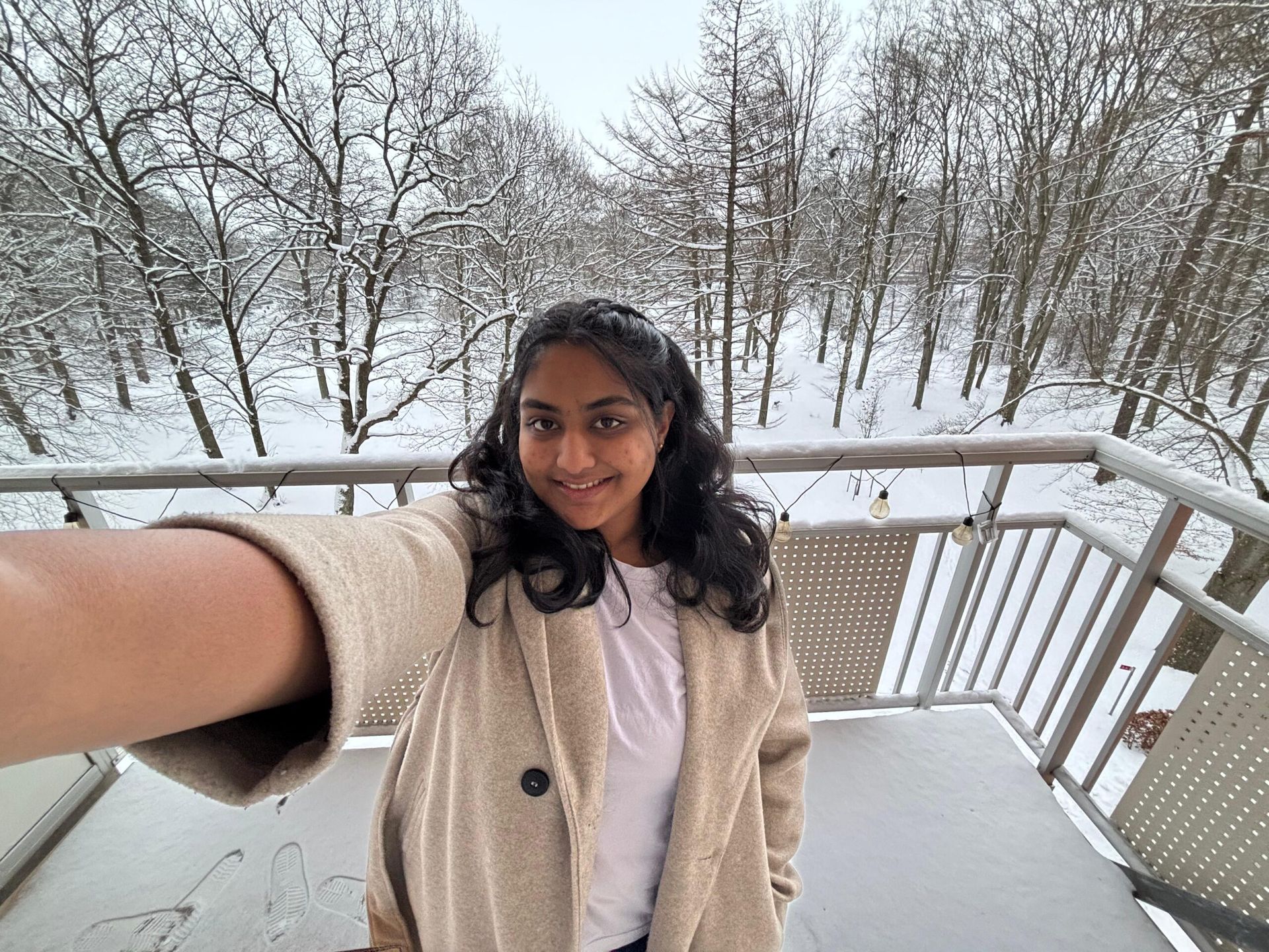 A selfie of a girl with a snowy background