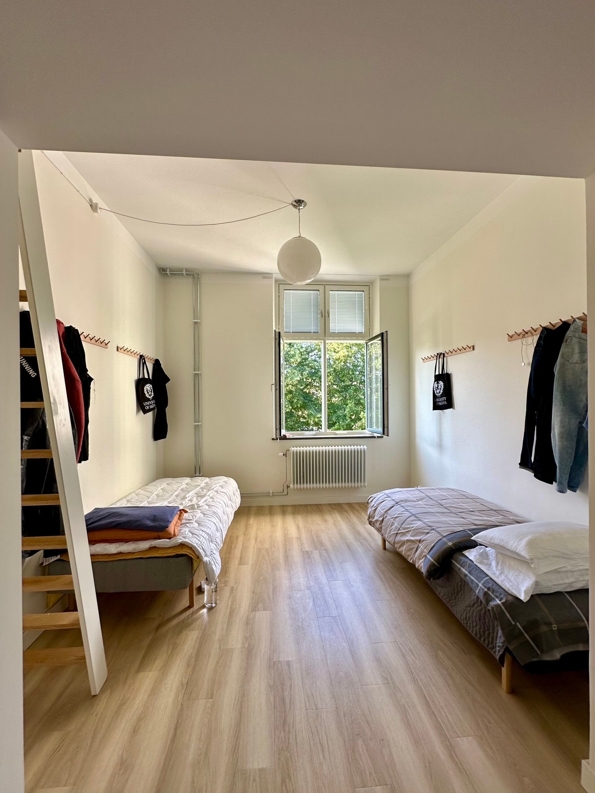 the interior of a student apartment with 2 beds