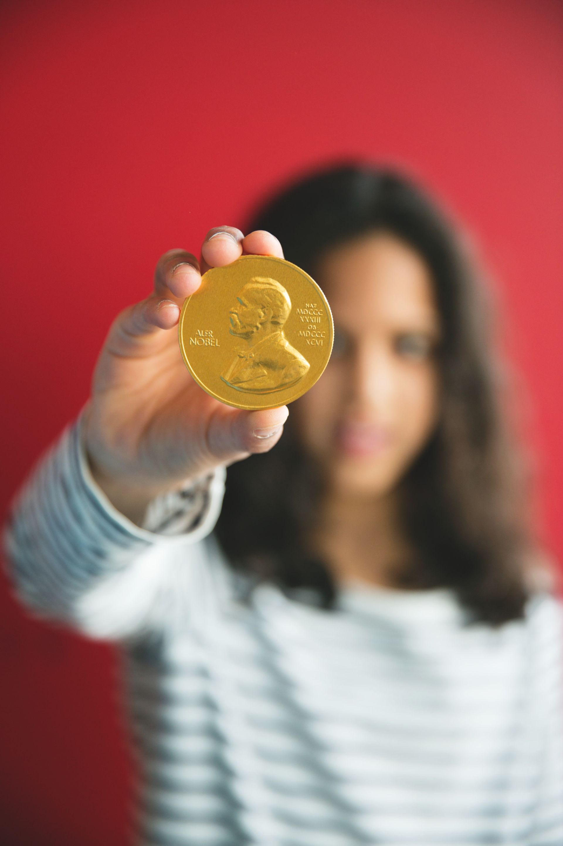 A woman holding the Nobel prize