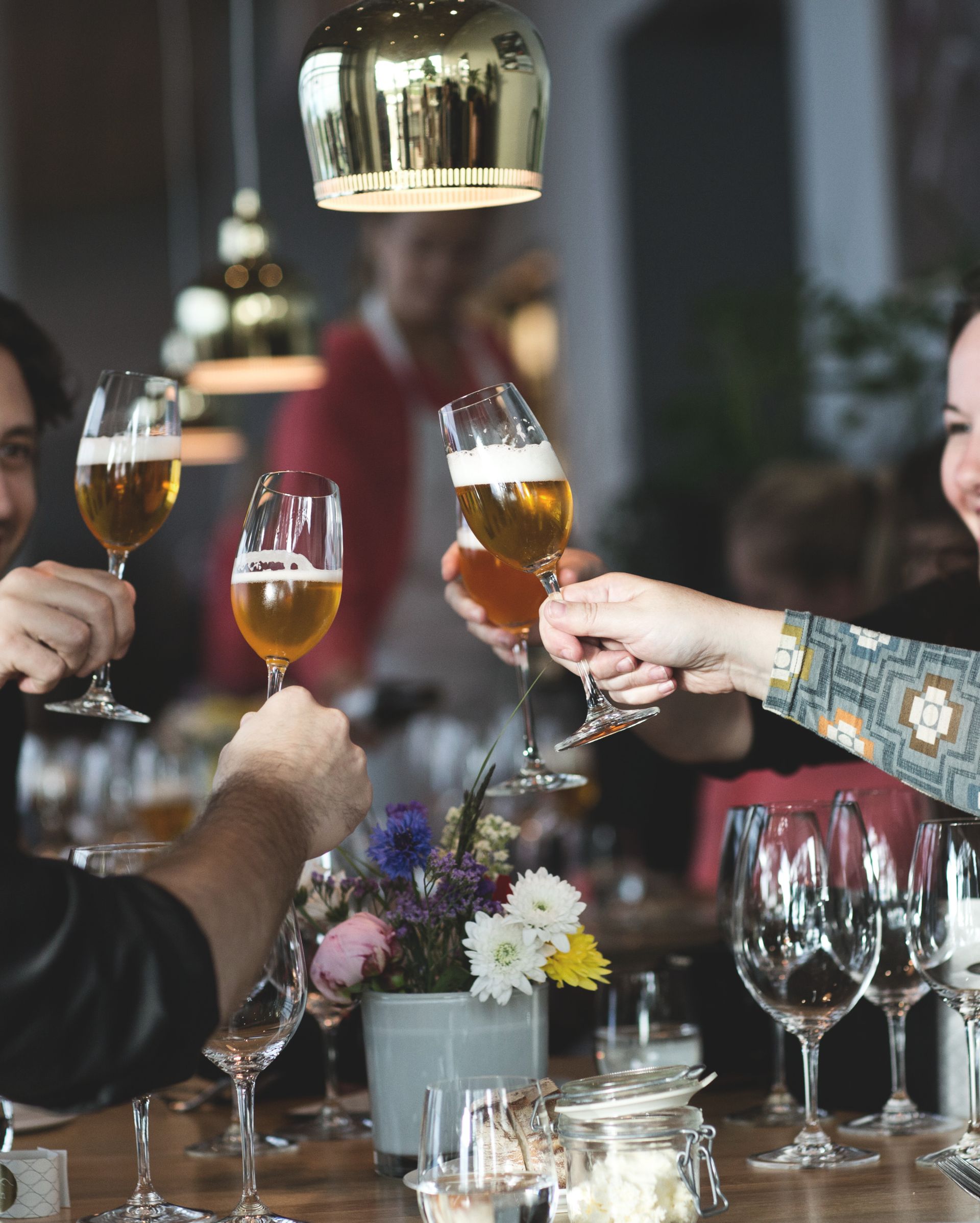 A group of people toasting with glasses of beer