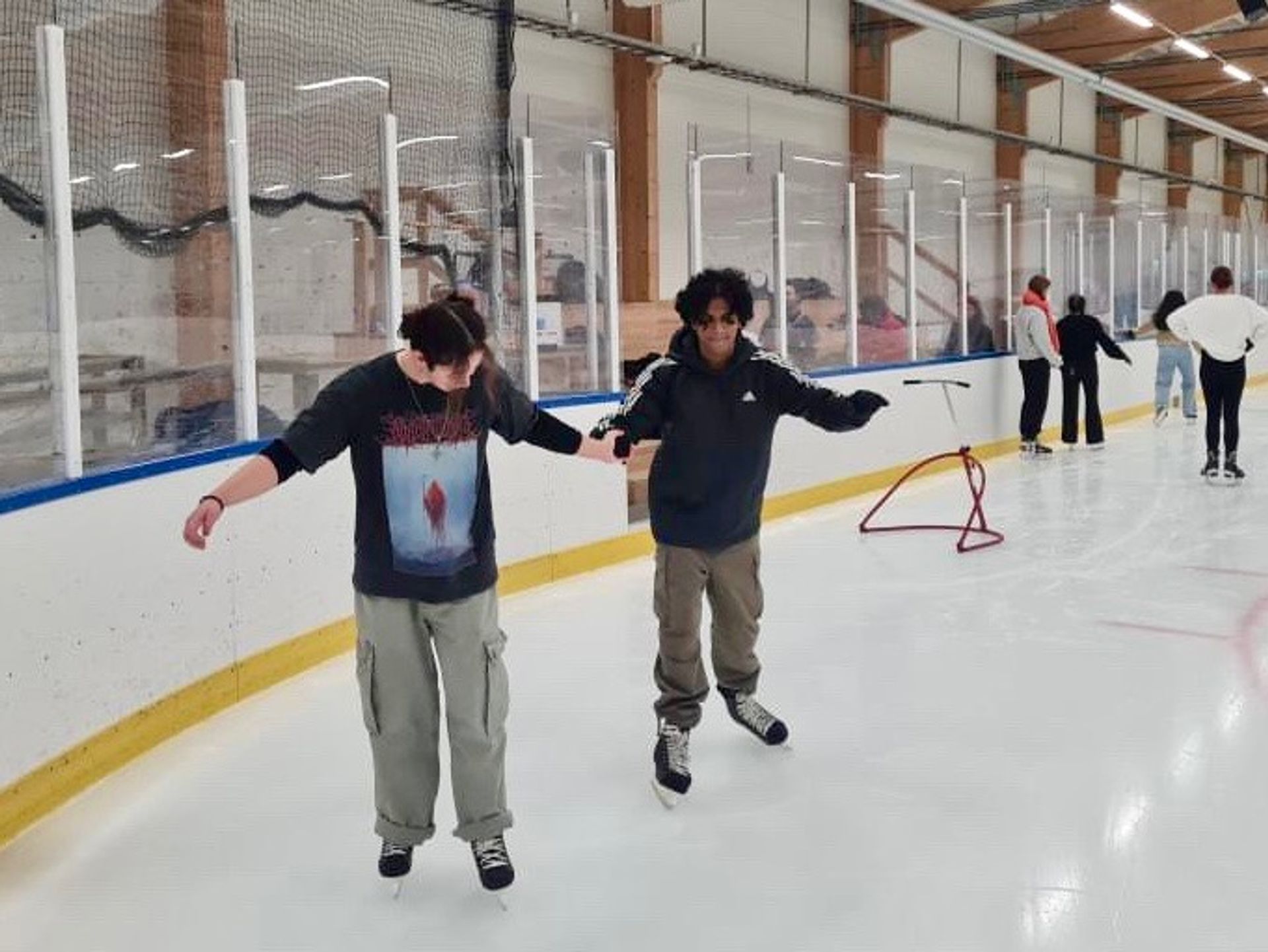 two friends ice skating together