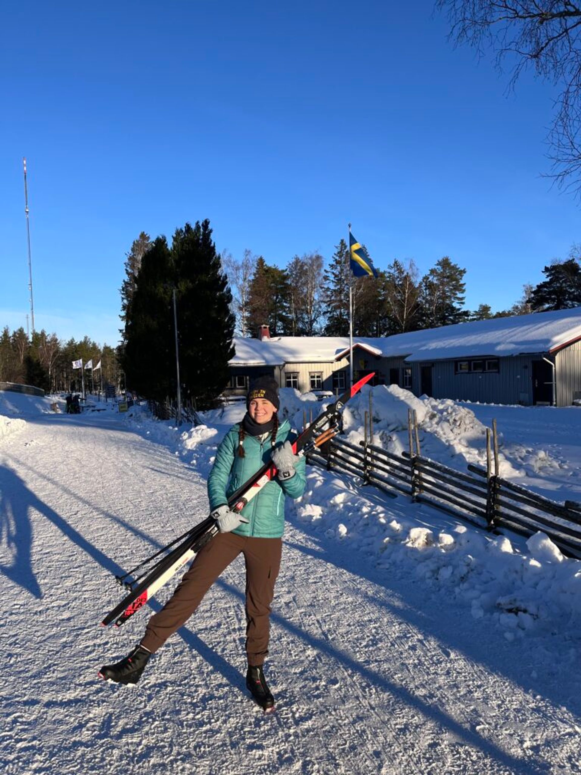A girl holding skis