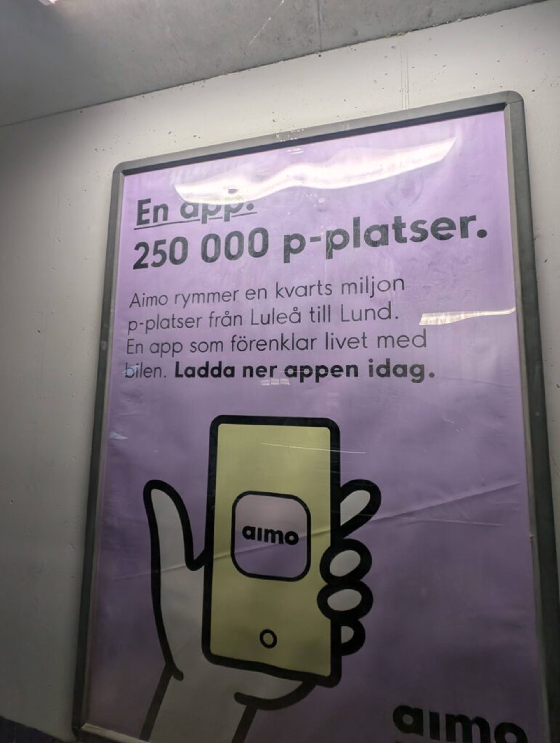 A picture of an informational sign for an Aimo parking lot.