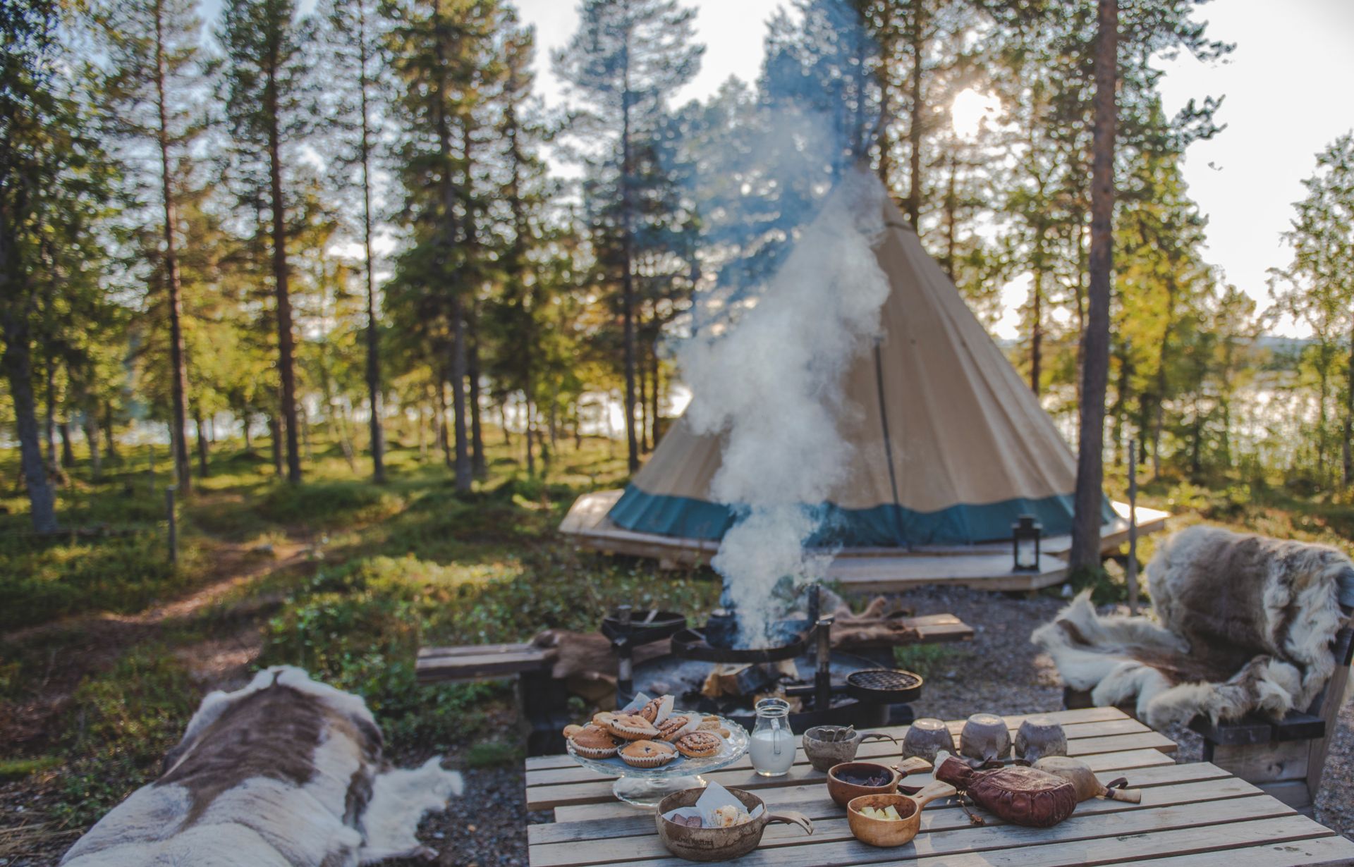 A campsite with a working grill and a table made