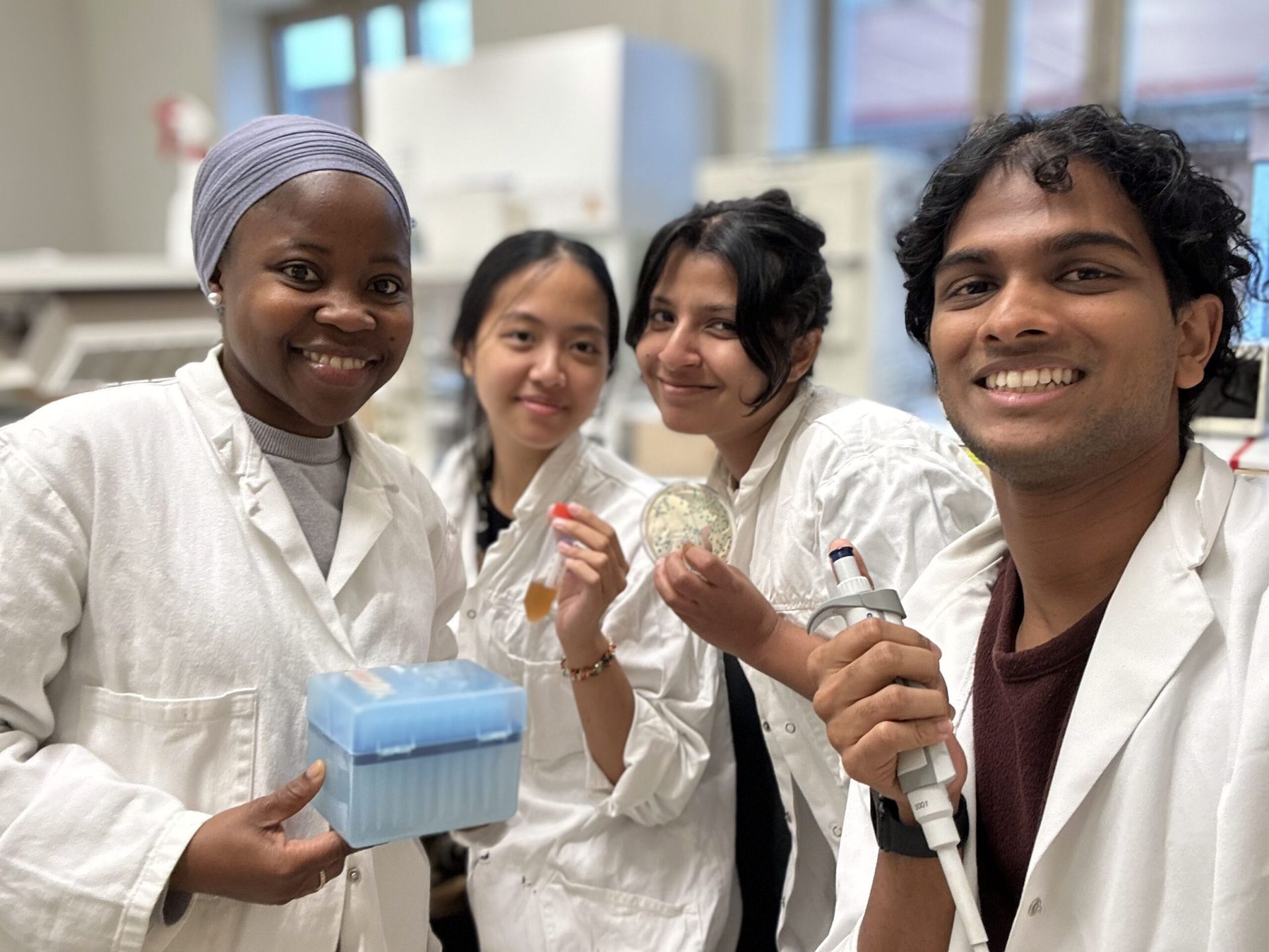 A selfie of four Students in a lab