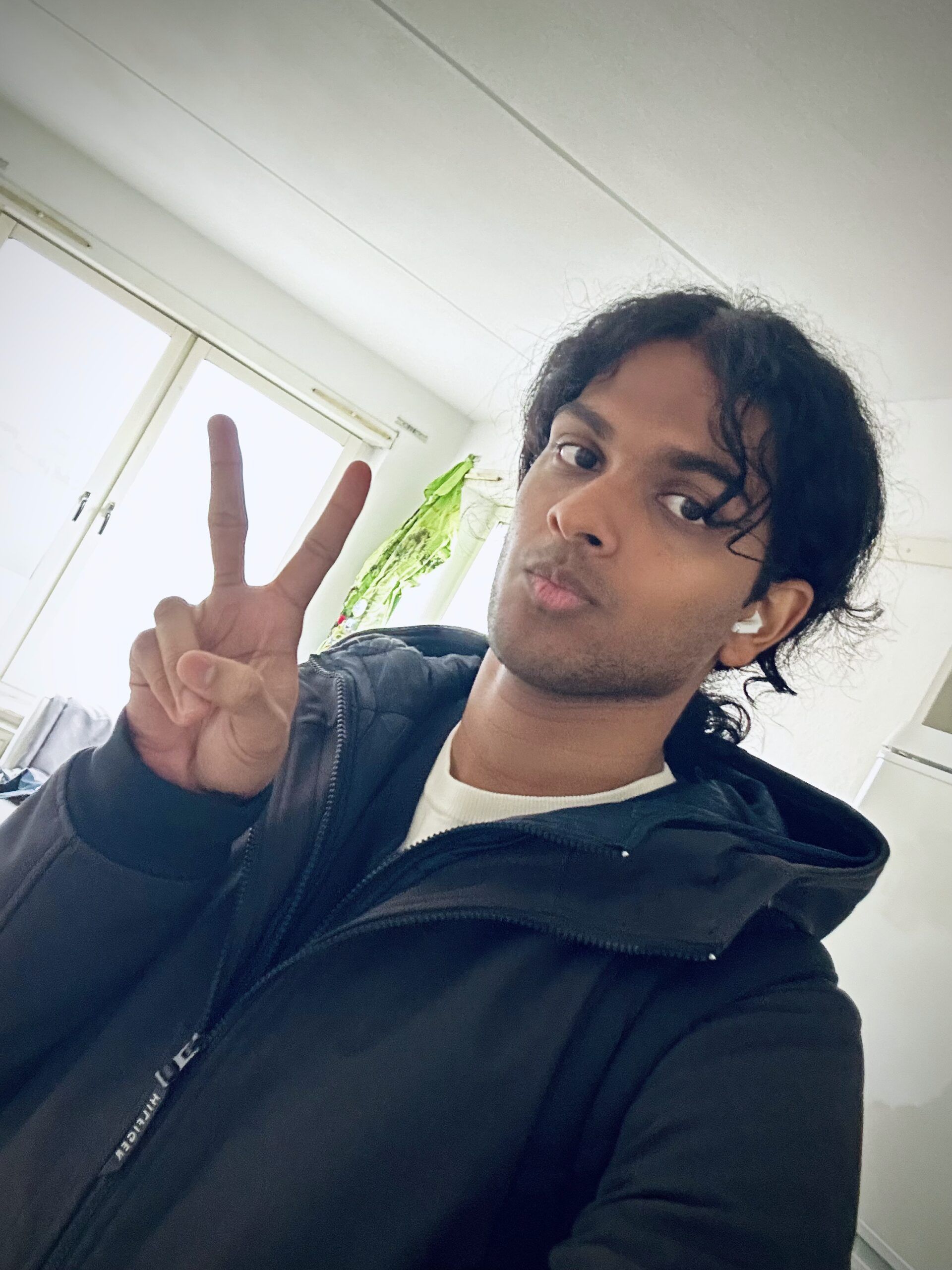 a selfie of the writer showing a peace sign