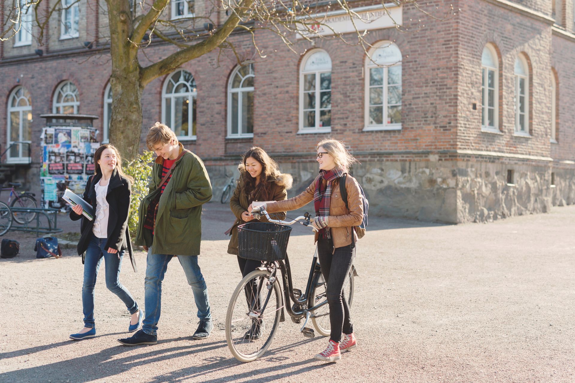 four university students walking outside