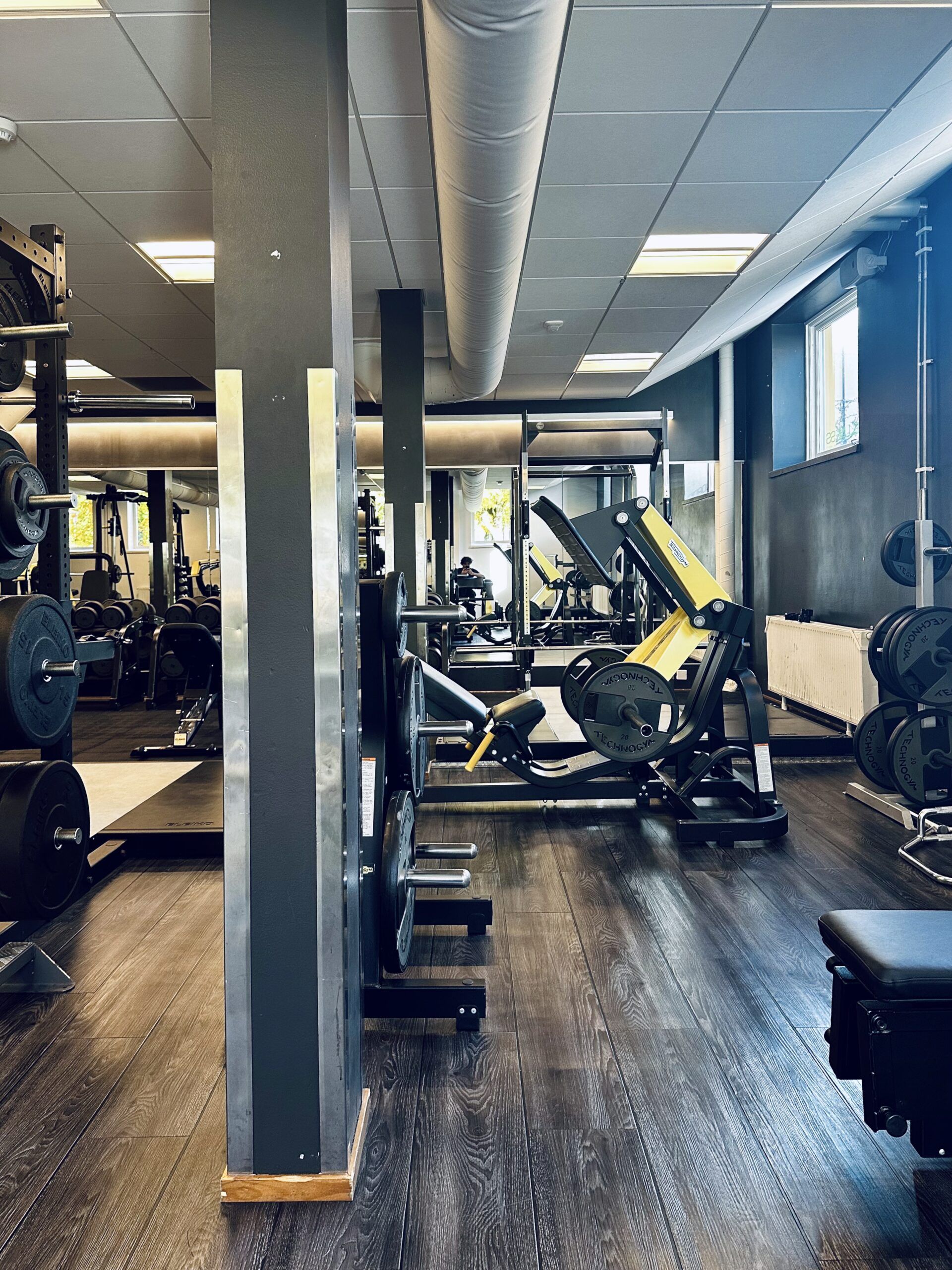 An interior of a gym filled with strength training machines
