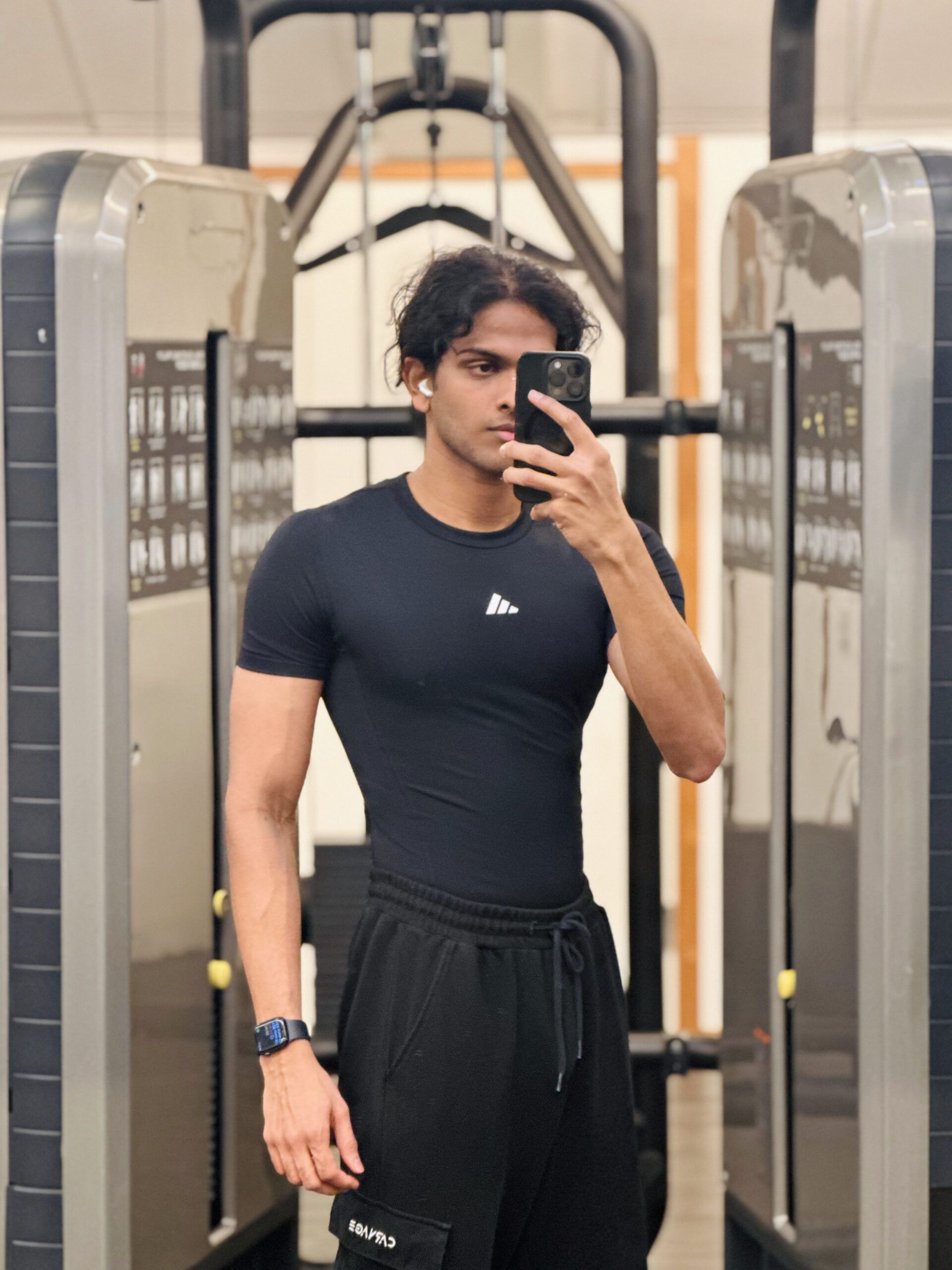 A boy taking a picture inside a gym