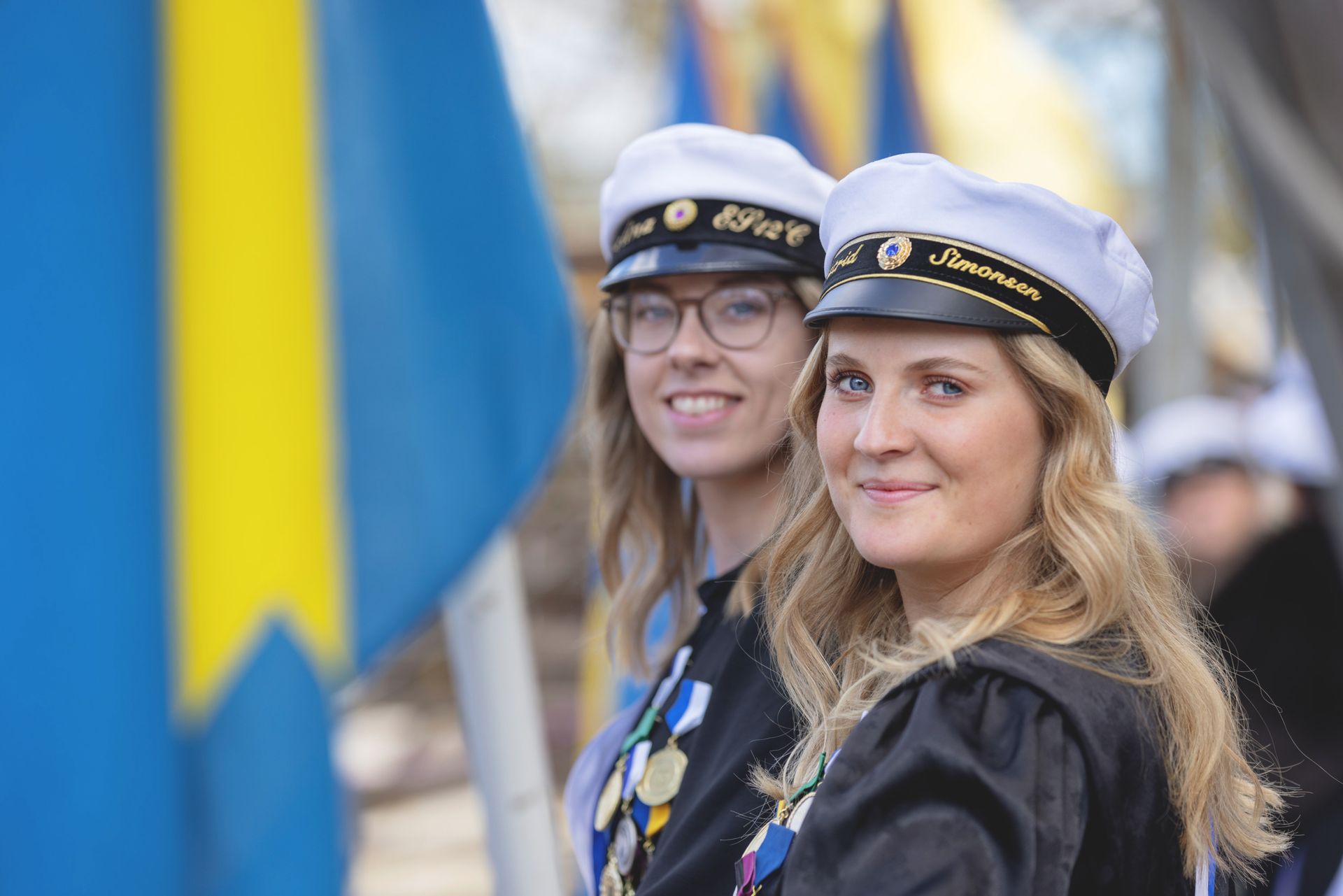 two graduating student with Swedish graduation caps