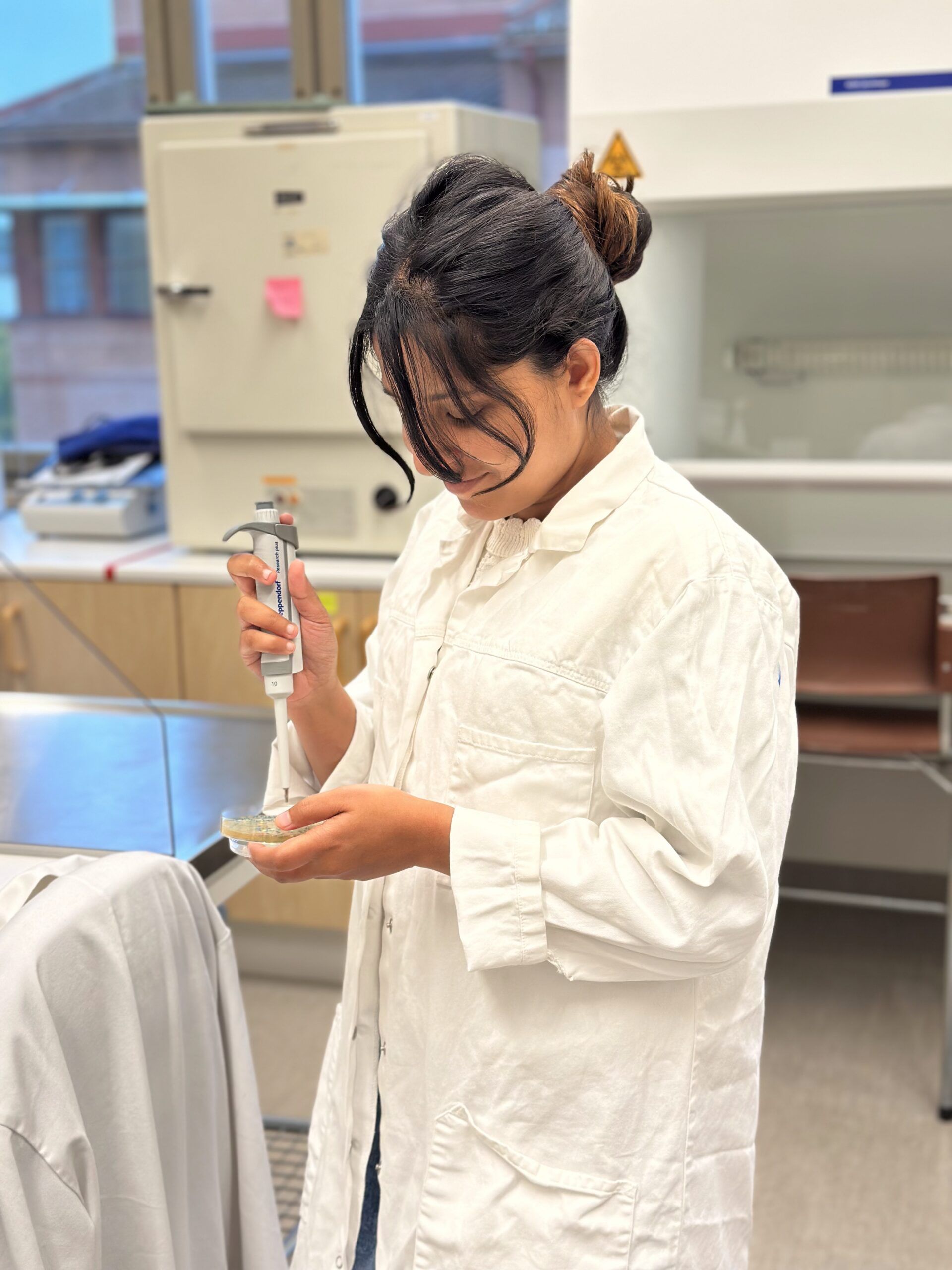 a student inside a biology lab handling equipment 