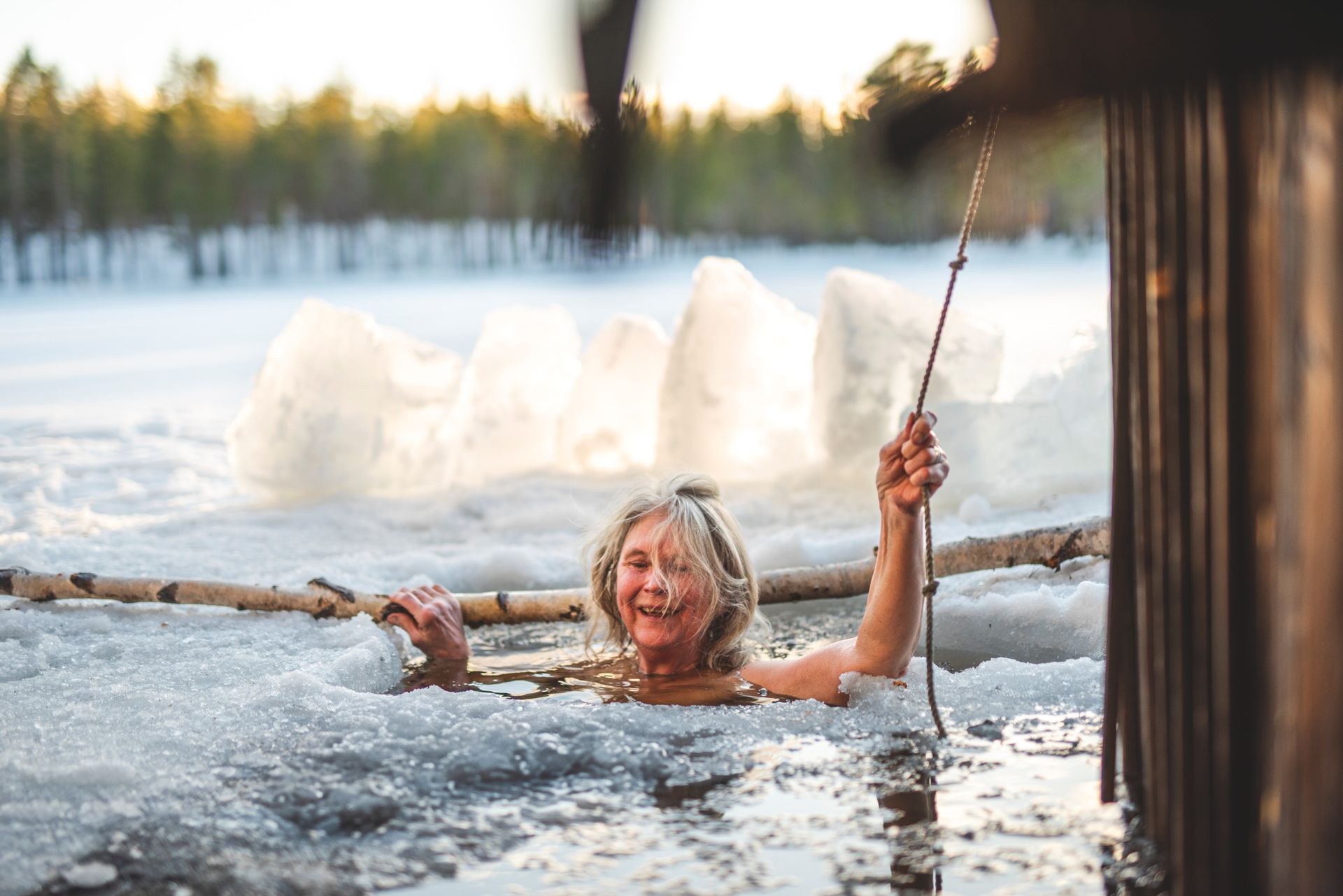 A woman having an ice bath outdoors