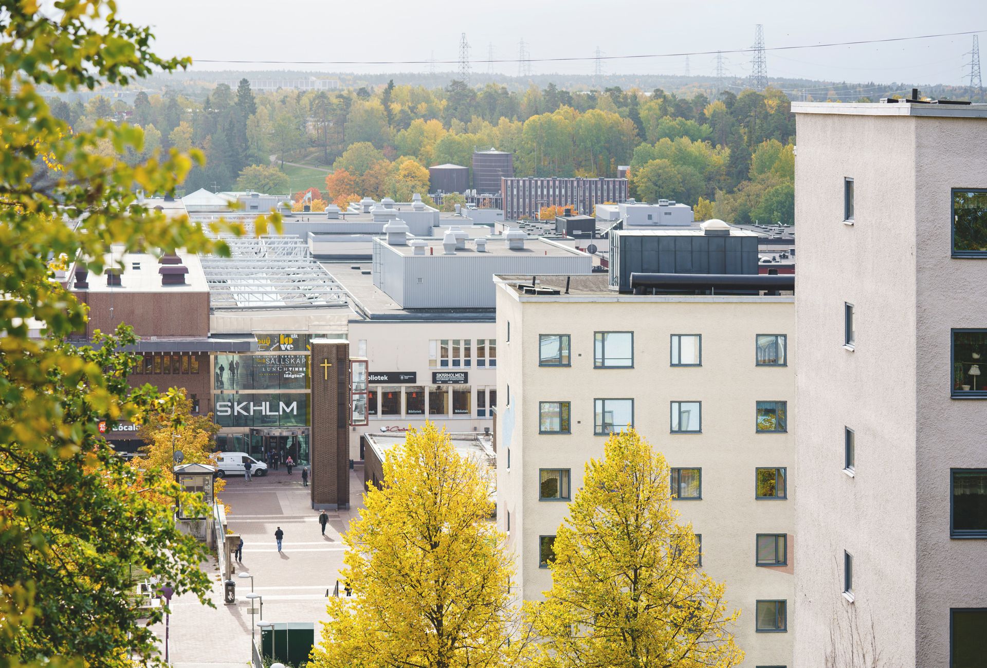 Tall residential buildings next to a suburban centre.